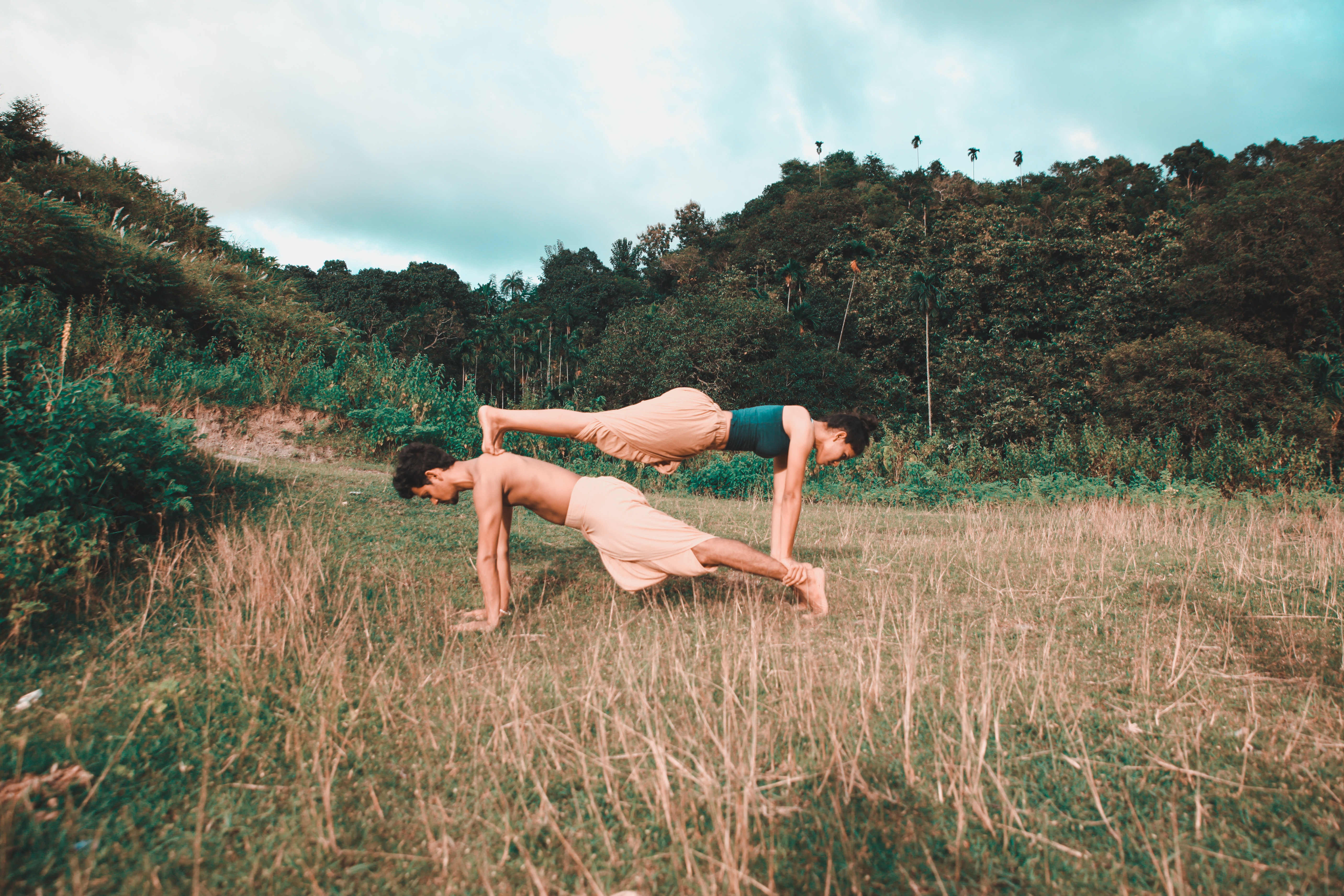 A couple practicing yoga together. | Source: Pexels
