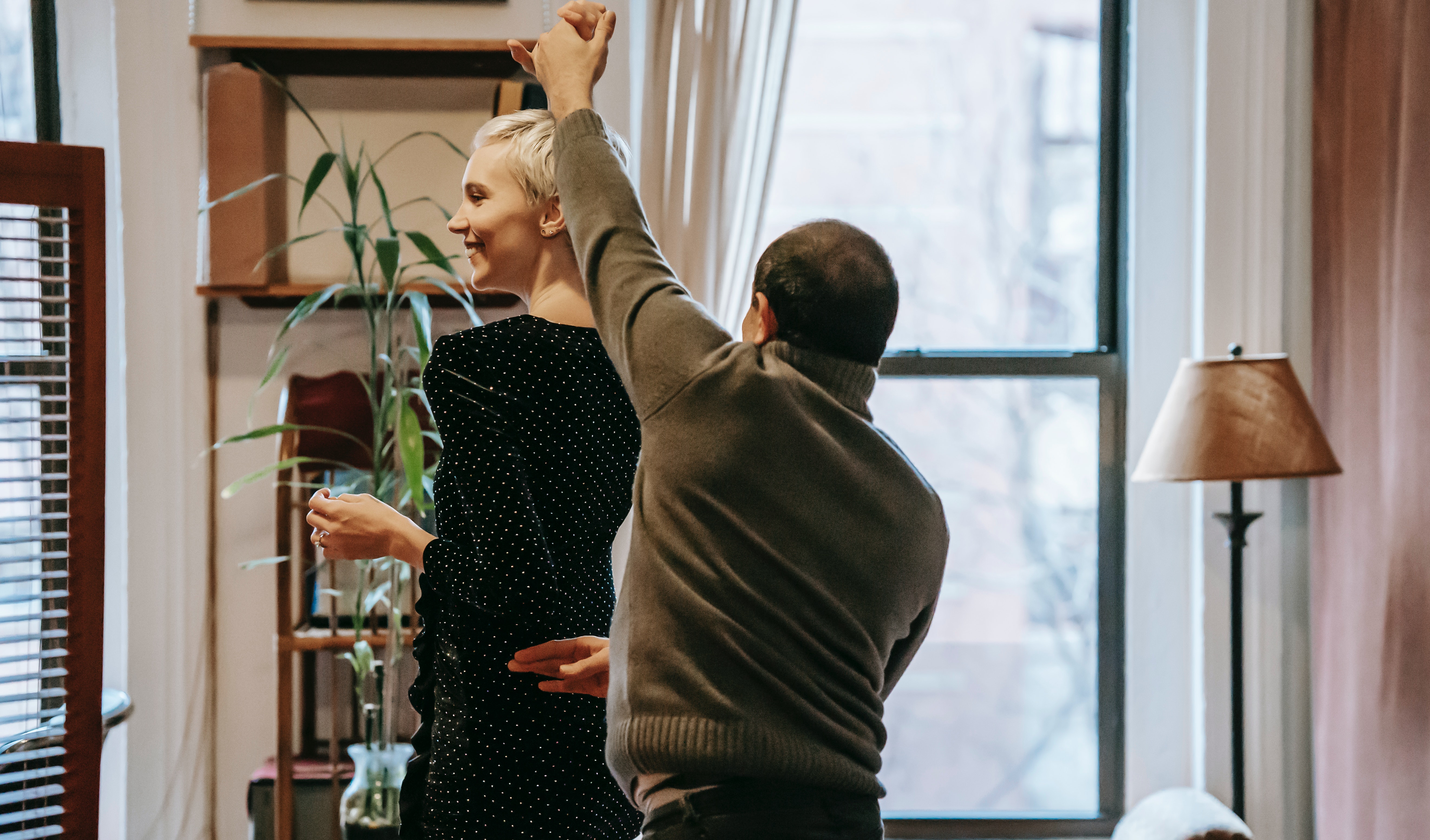 A man and woman playfully dancing. | Source: Pexels