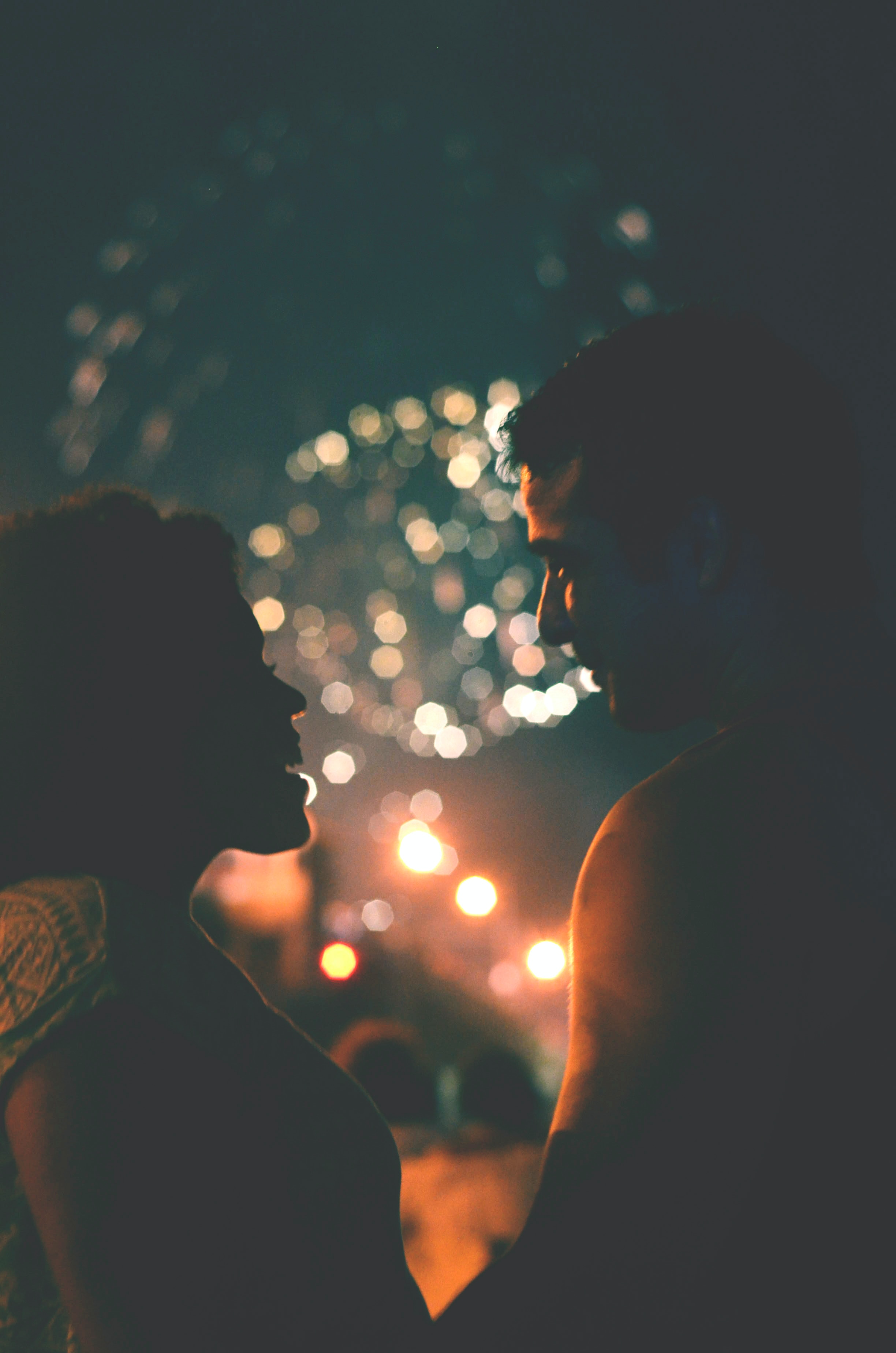 A couple with fireworks in the background. | Source: Unsplash