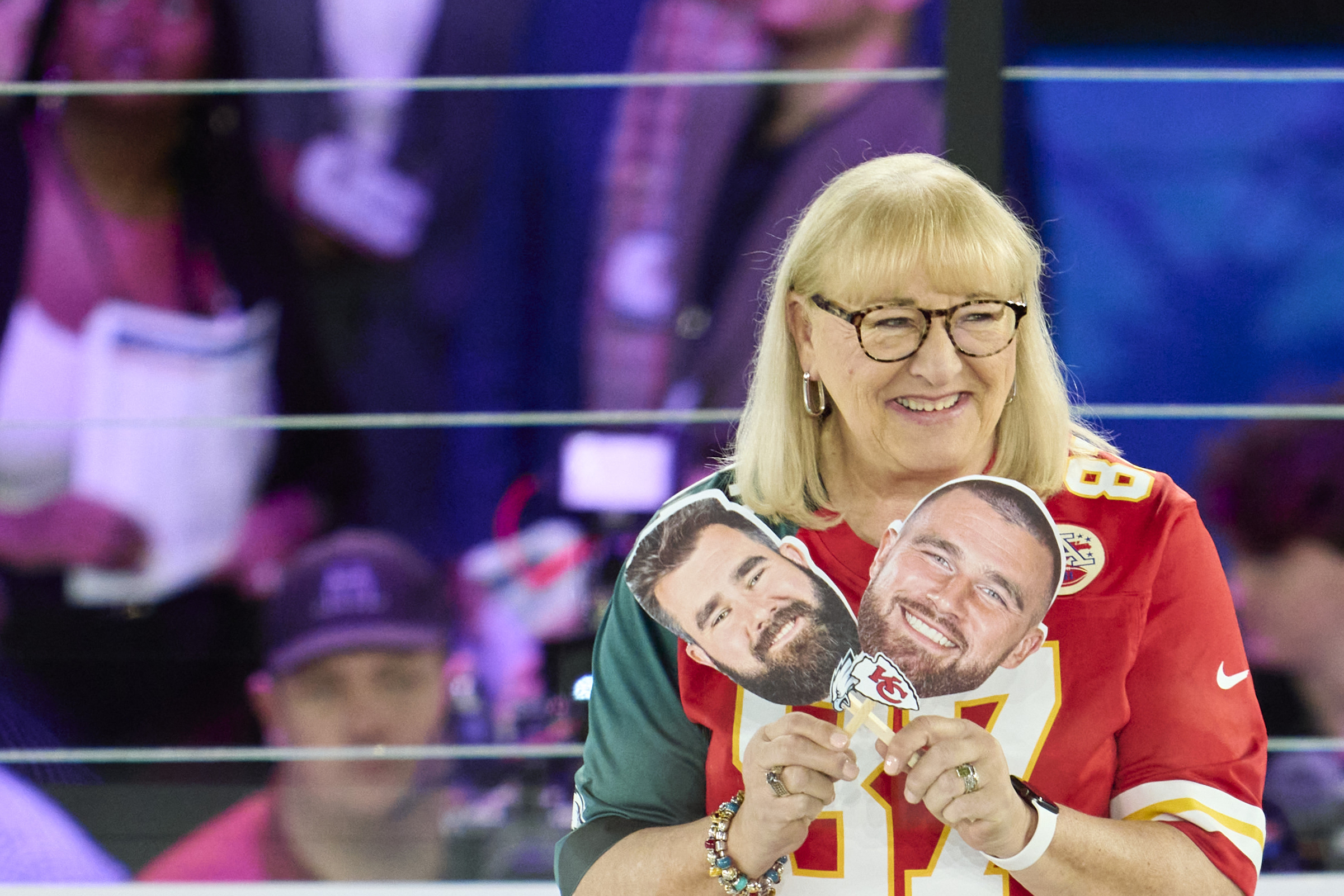 Donna Kelce holds up photos of her sons, Jason Kelce and Travis Kelce at Footprint Center in Phoenix, Arizona, on February 6, 2023 | Source: Getty Images