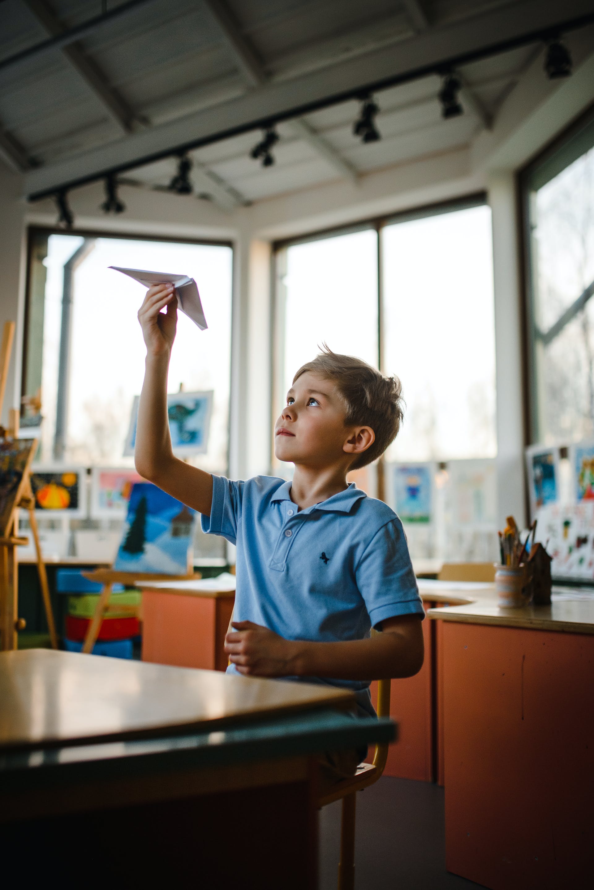 A child holding a paper plane | Source: Pexels