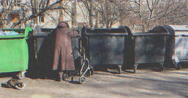 An old woman searching in a dumpster | Source: Shutterstock