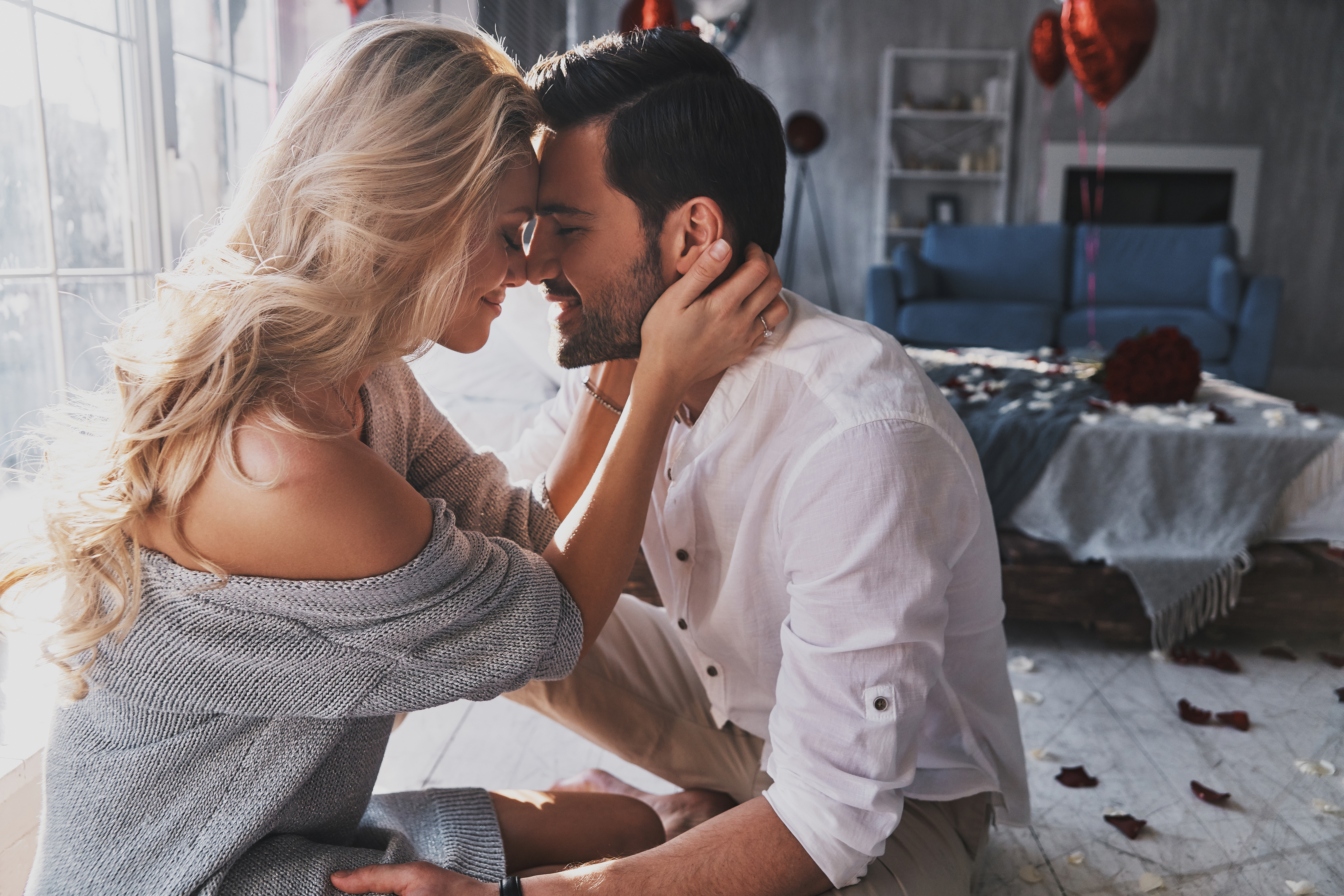 A young couple poses while holding each other | Source: Shutterstock