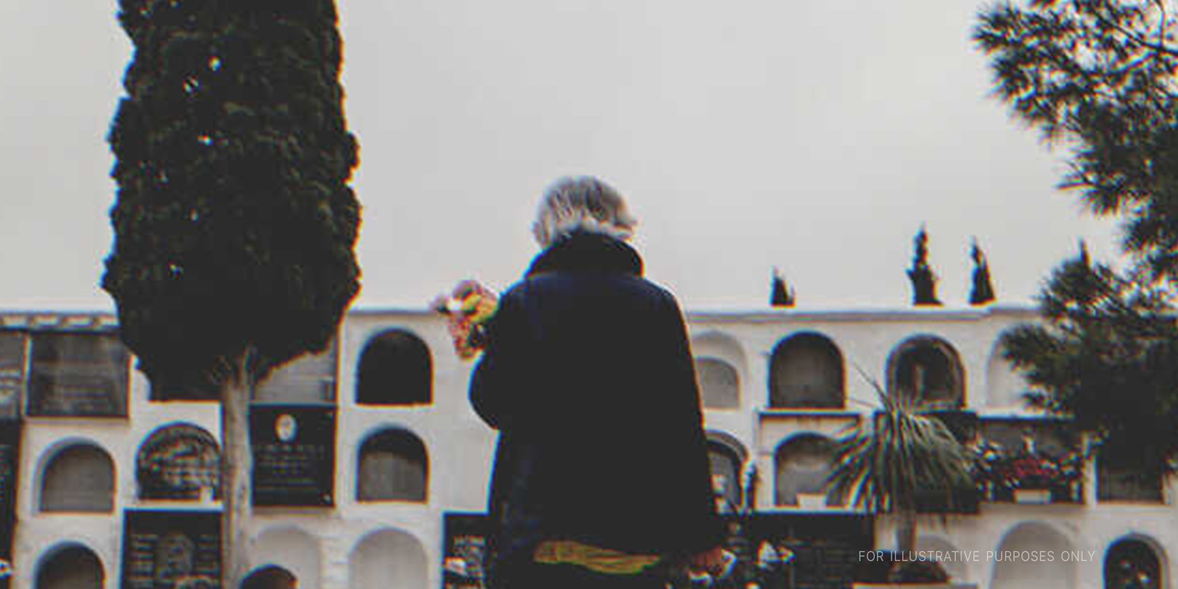 An Elderly Woman Mourning In A Cemetery | Source: Getty Images