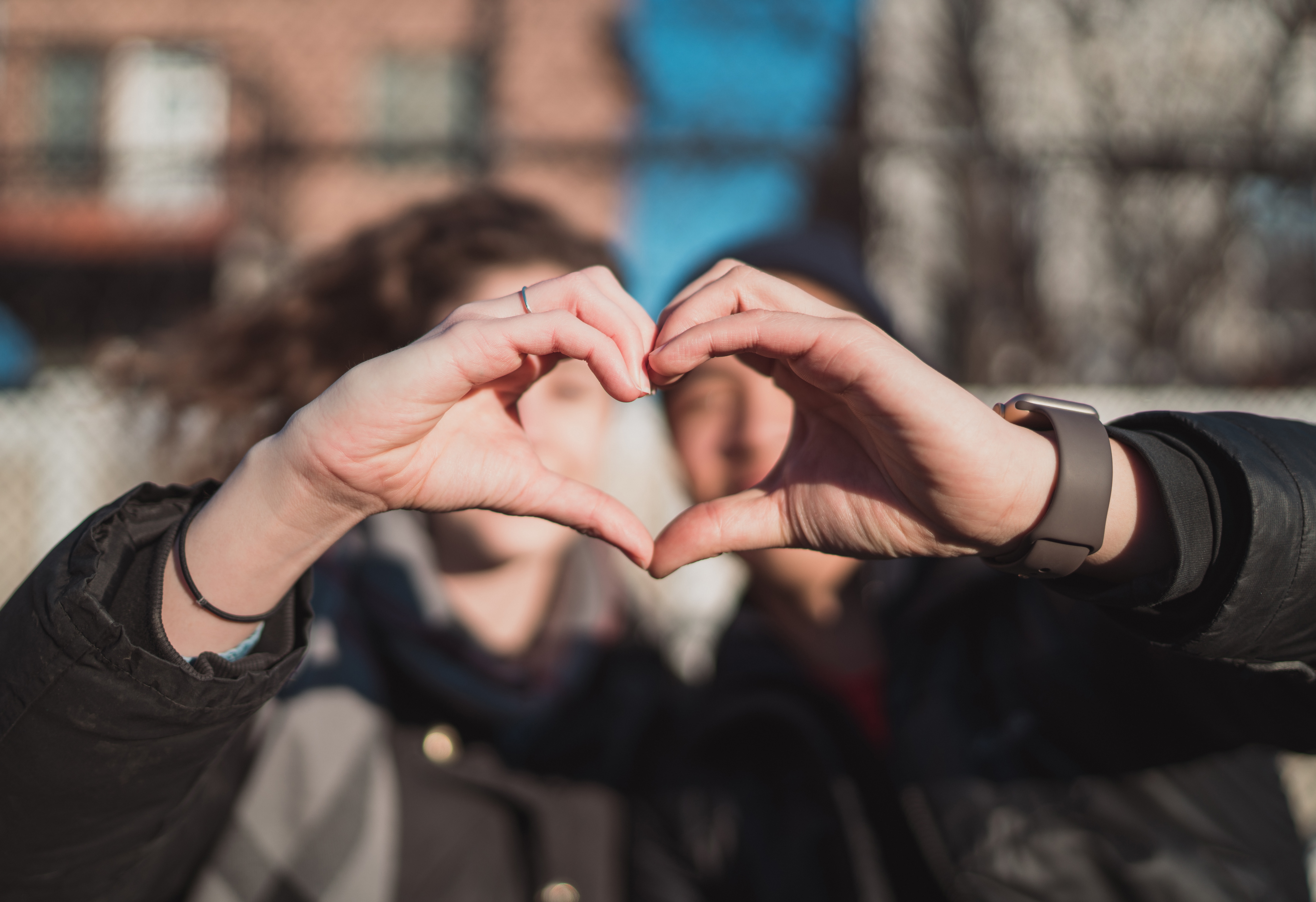 Couple forming heart with their hands | Source: Unsplash