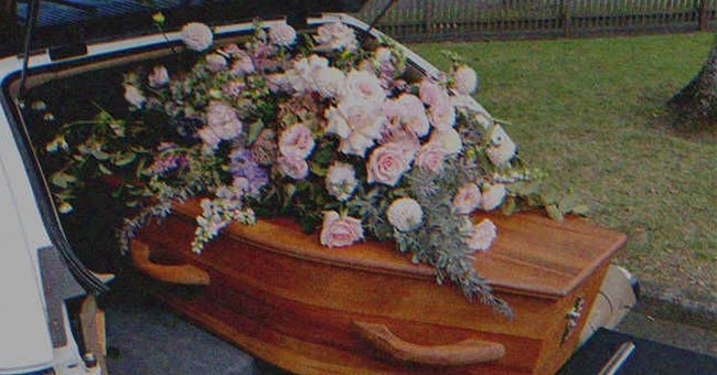 A coffin with flowers on top | Source: Shutterstock