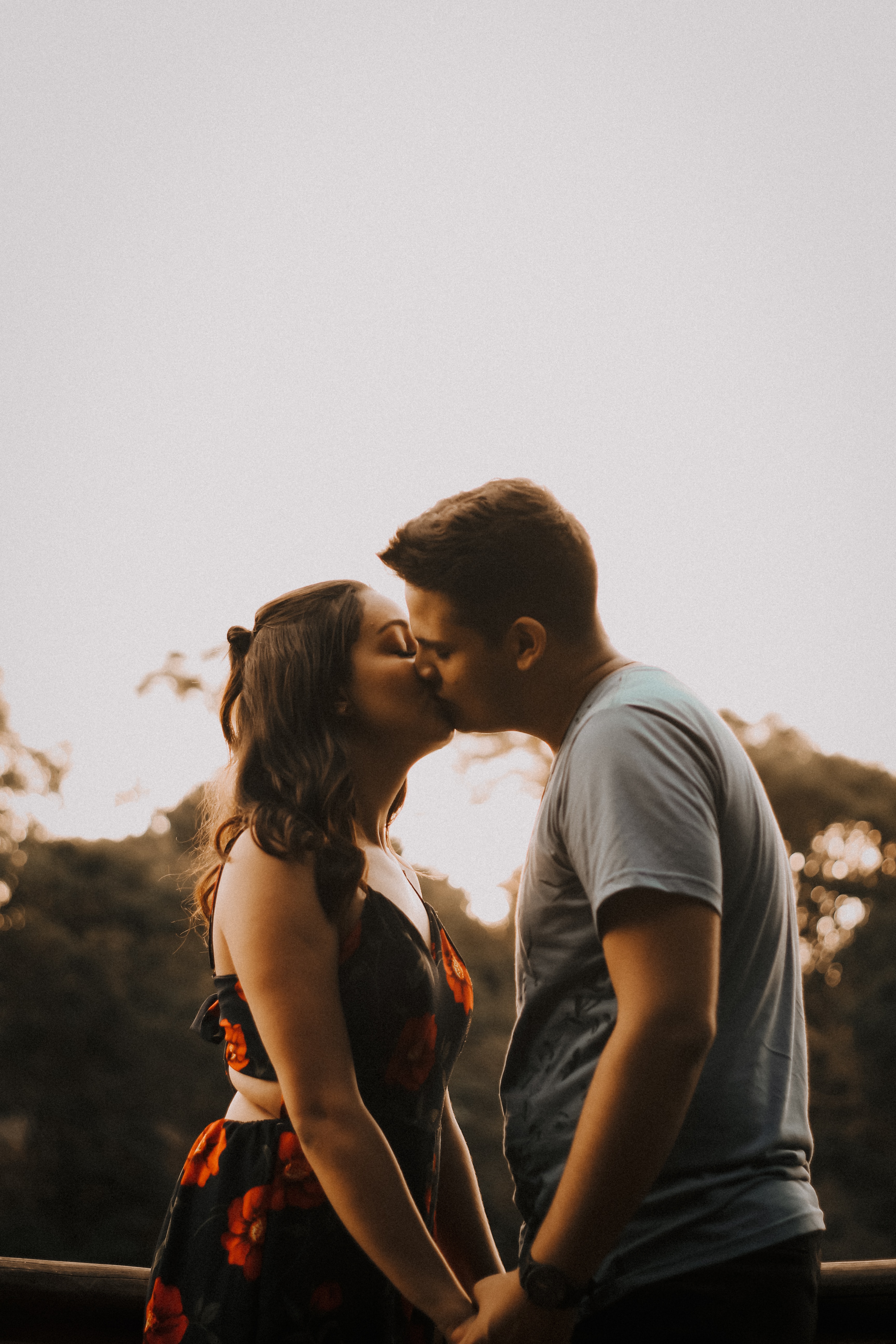A photo of a couple kissing while holding hands  | Source: Unsplash