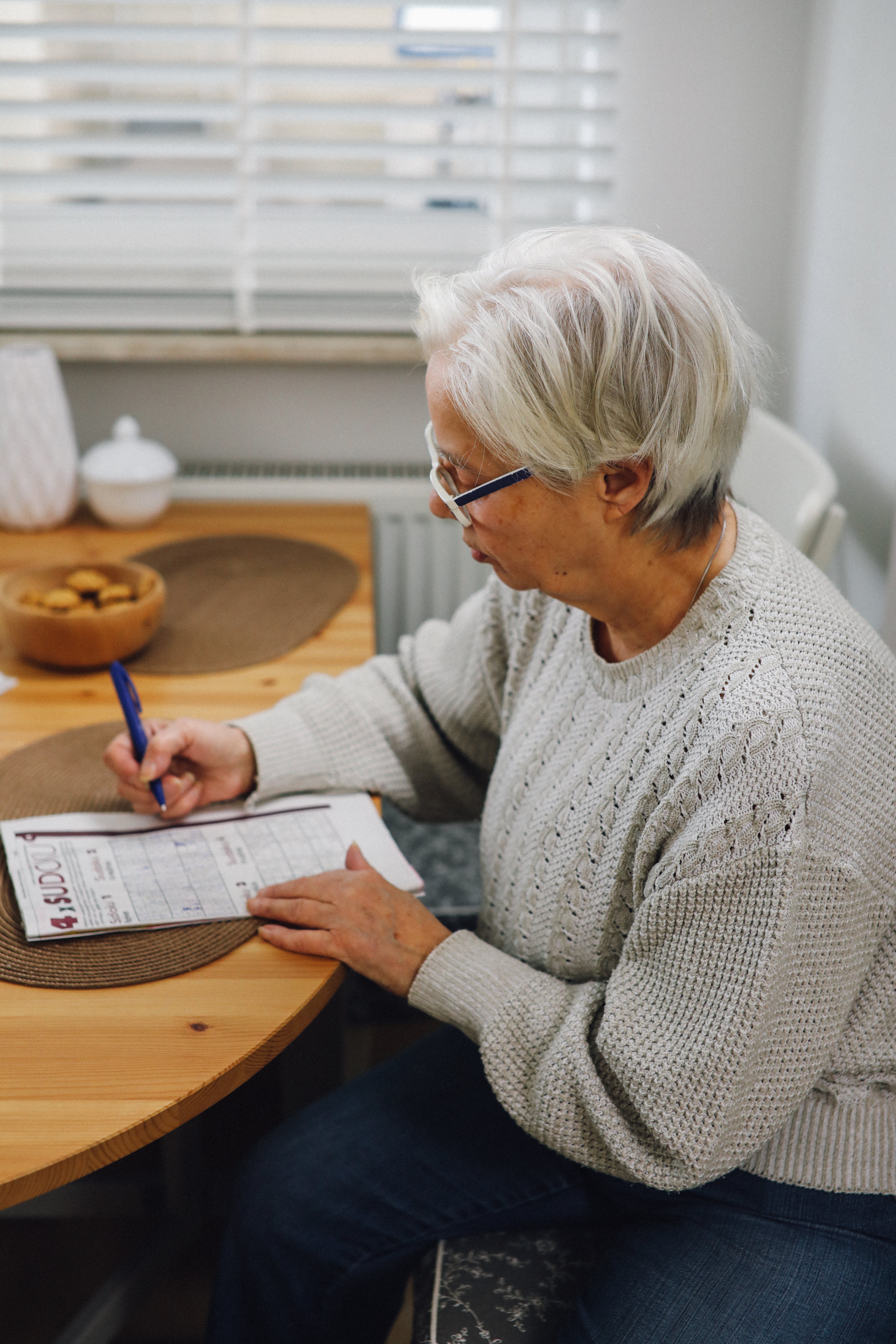 Una anciana escribiendo en un papel. | Fuente: Pexels