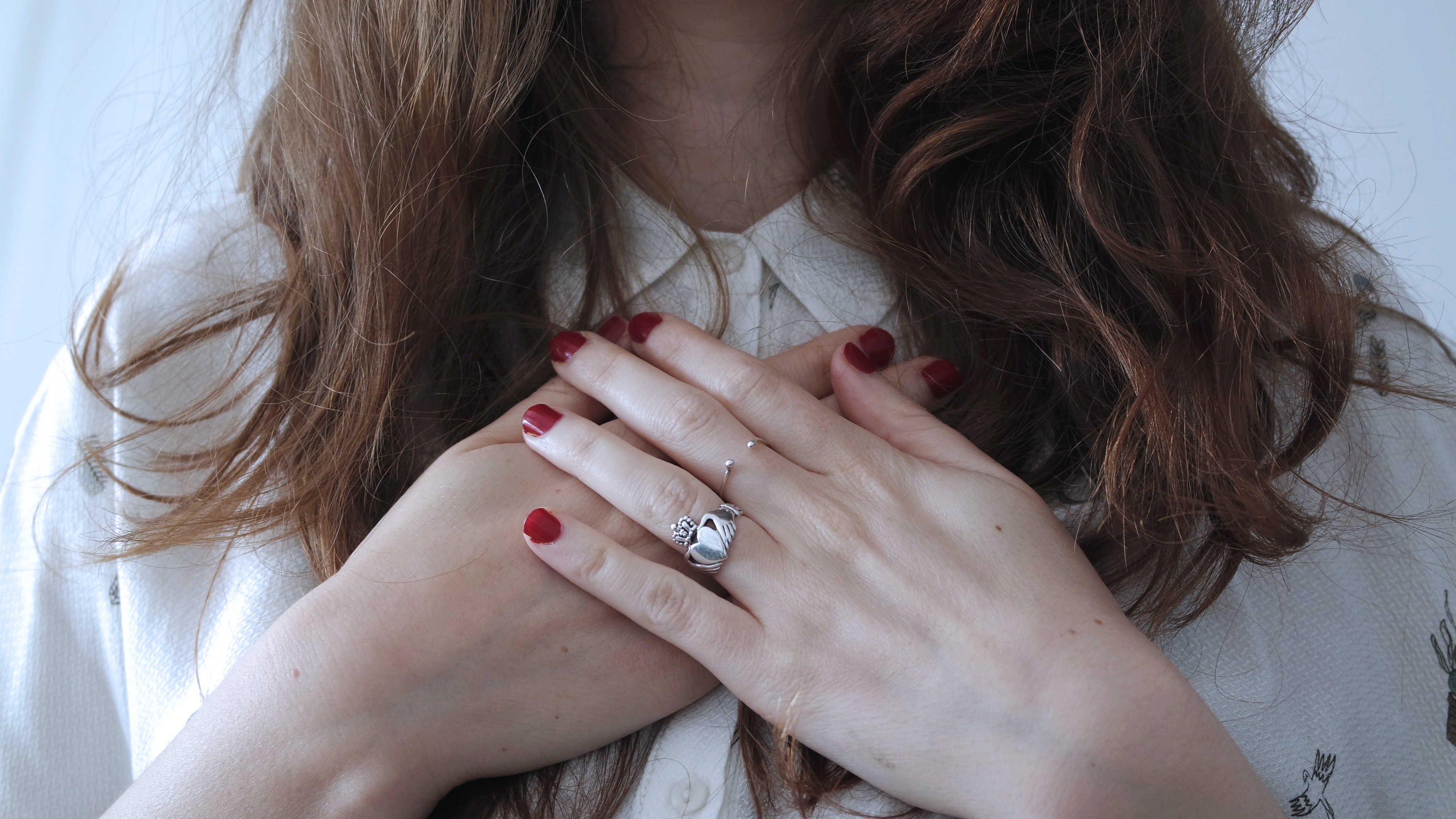 A woman placing her hands on her chest.| Source: Unsplash