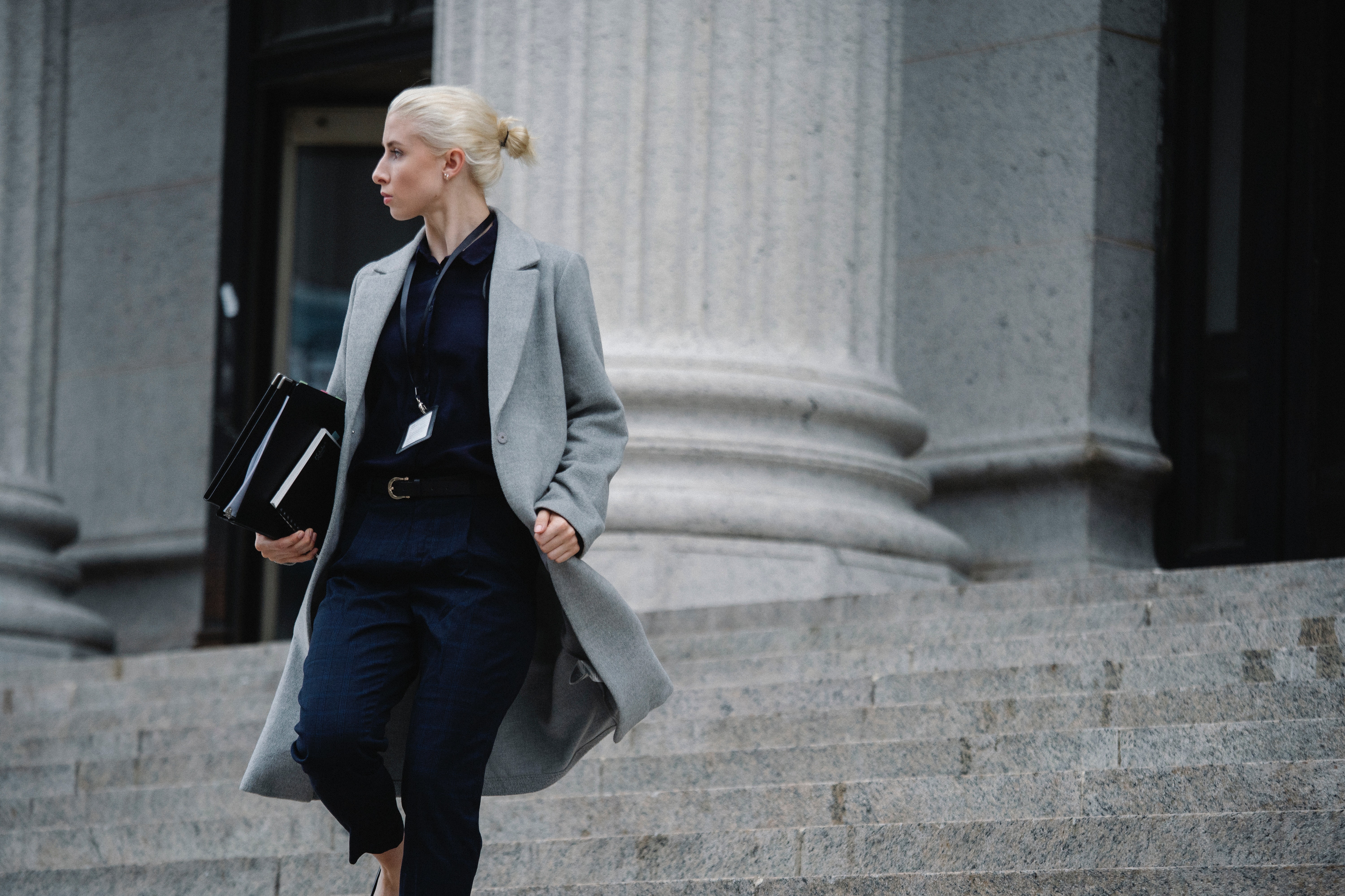 A woman walking down courthouse stairs. | Source: Pexels