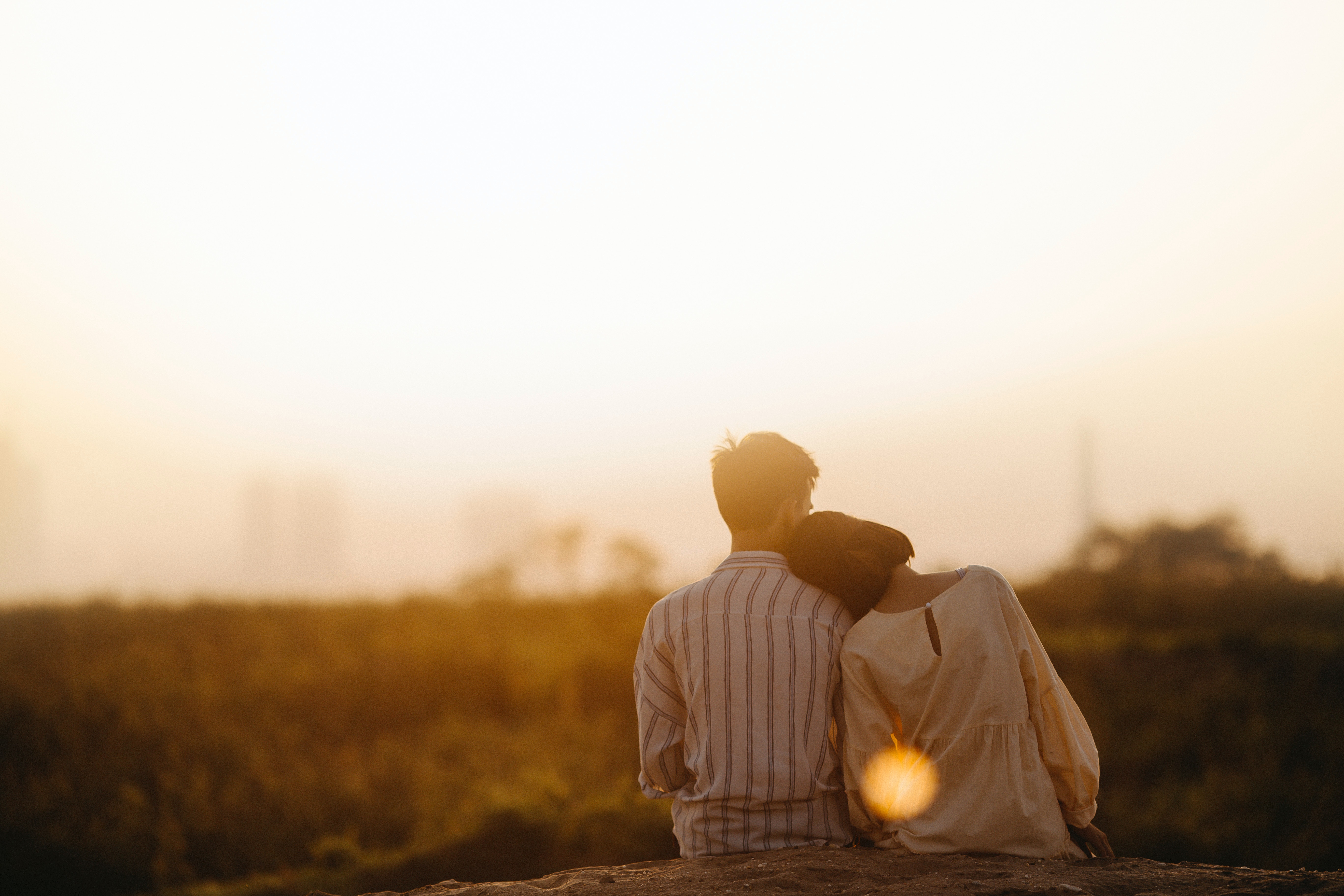 A couple watching the sun set.  | Source: Pexels