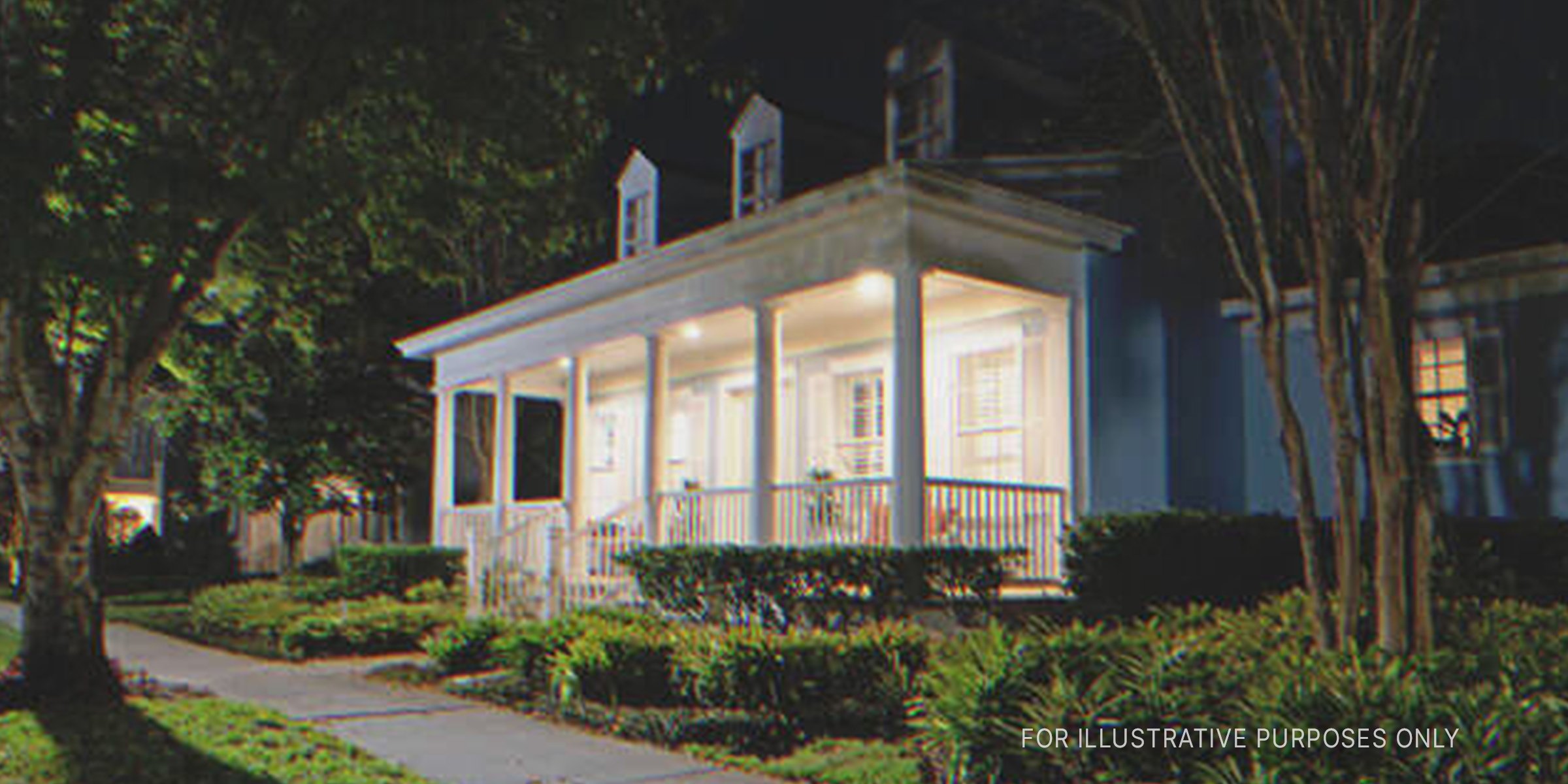 A suburban home with porch lights on | Source: Shutterstock