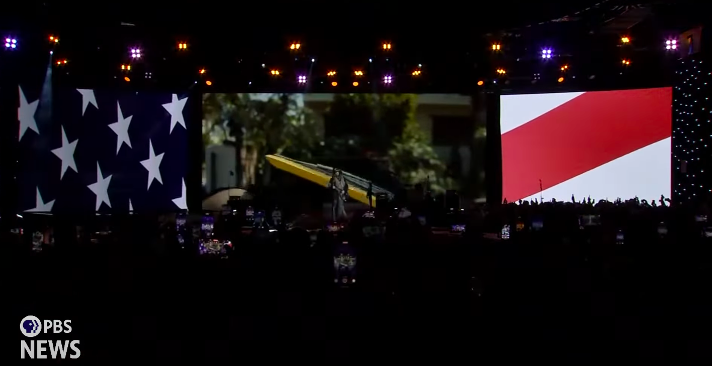 Billy Ray Cyrus attempting to strum along with the "Old Town Road" music video. | Source: YouTube/PBS NewsHour