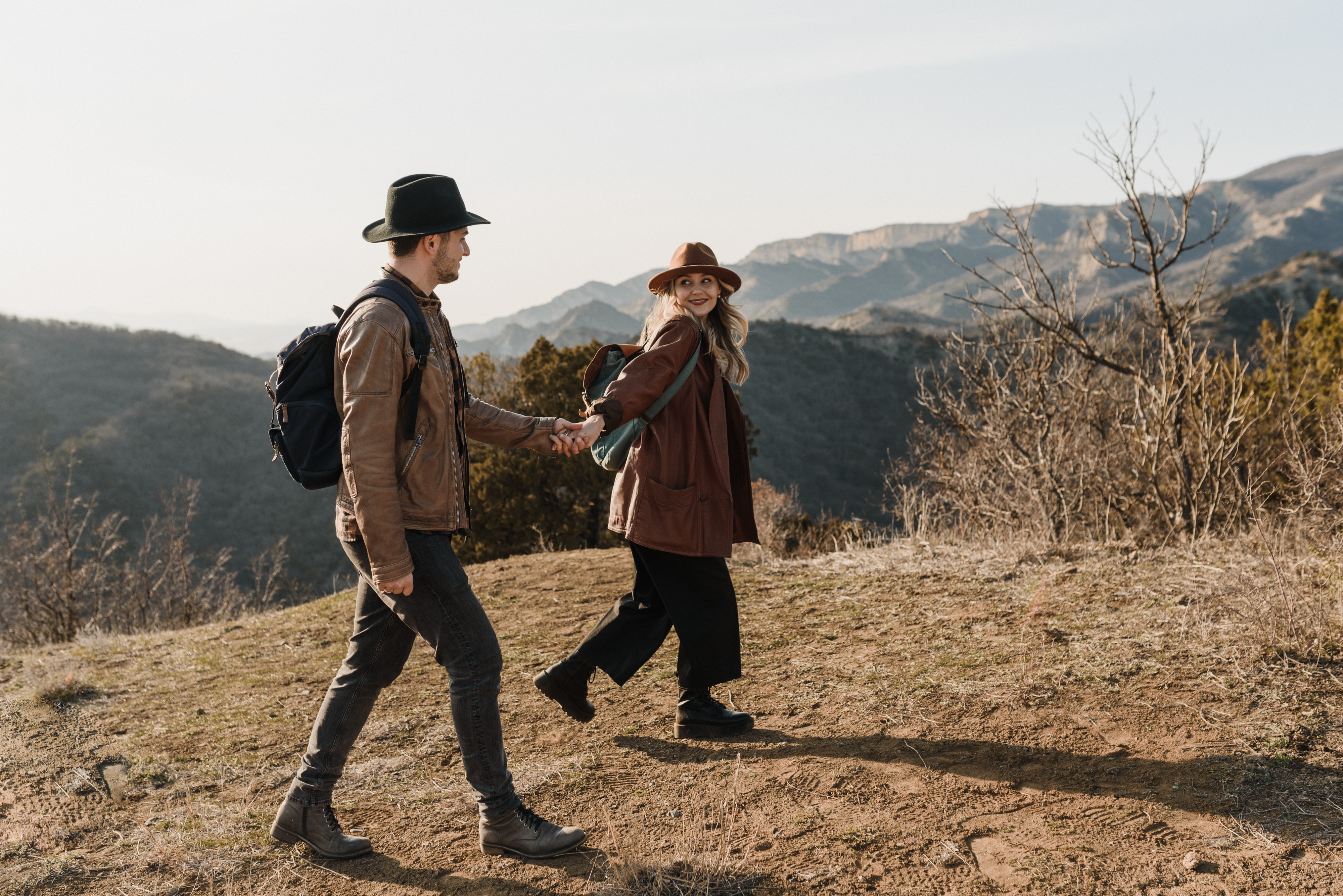 A woman lovingly looks at her partner as they stroll outdoors. | Source: Pexels