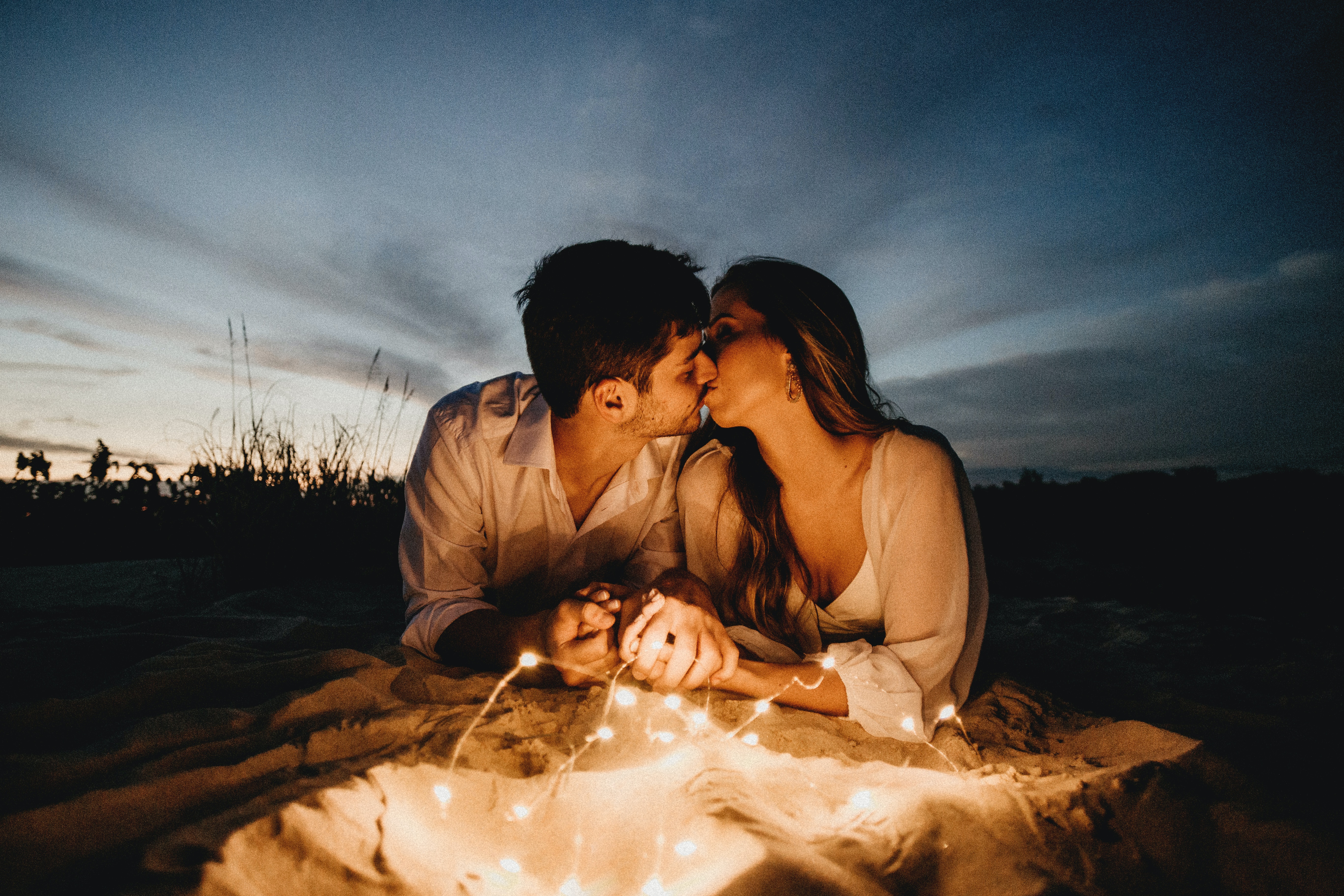 A photo of a couple kissing at nighttime  | Source: Unsplash