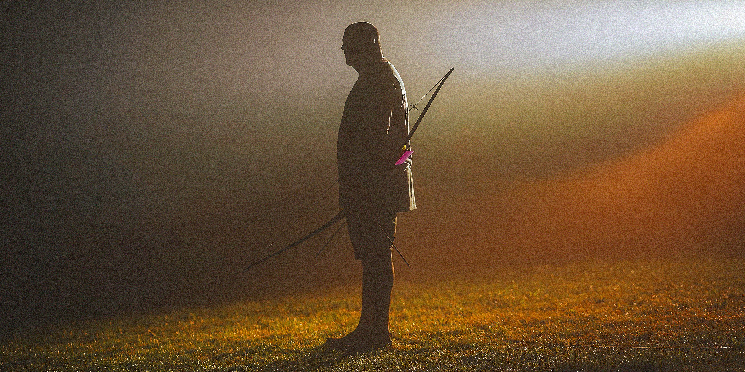Unsplash | A man holding a bow and arrow
