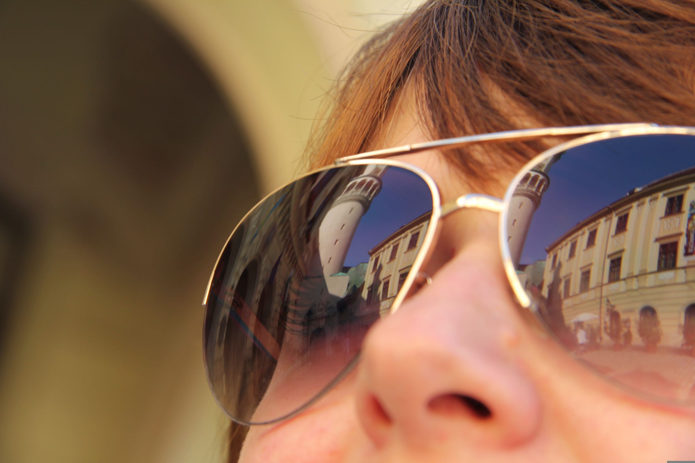 A woman looking at buildings reflected in her sunglasses. | Source: Pixabay