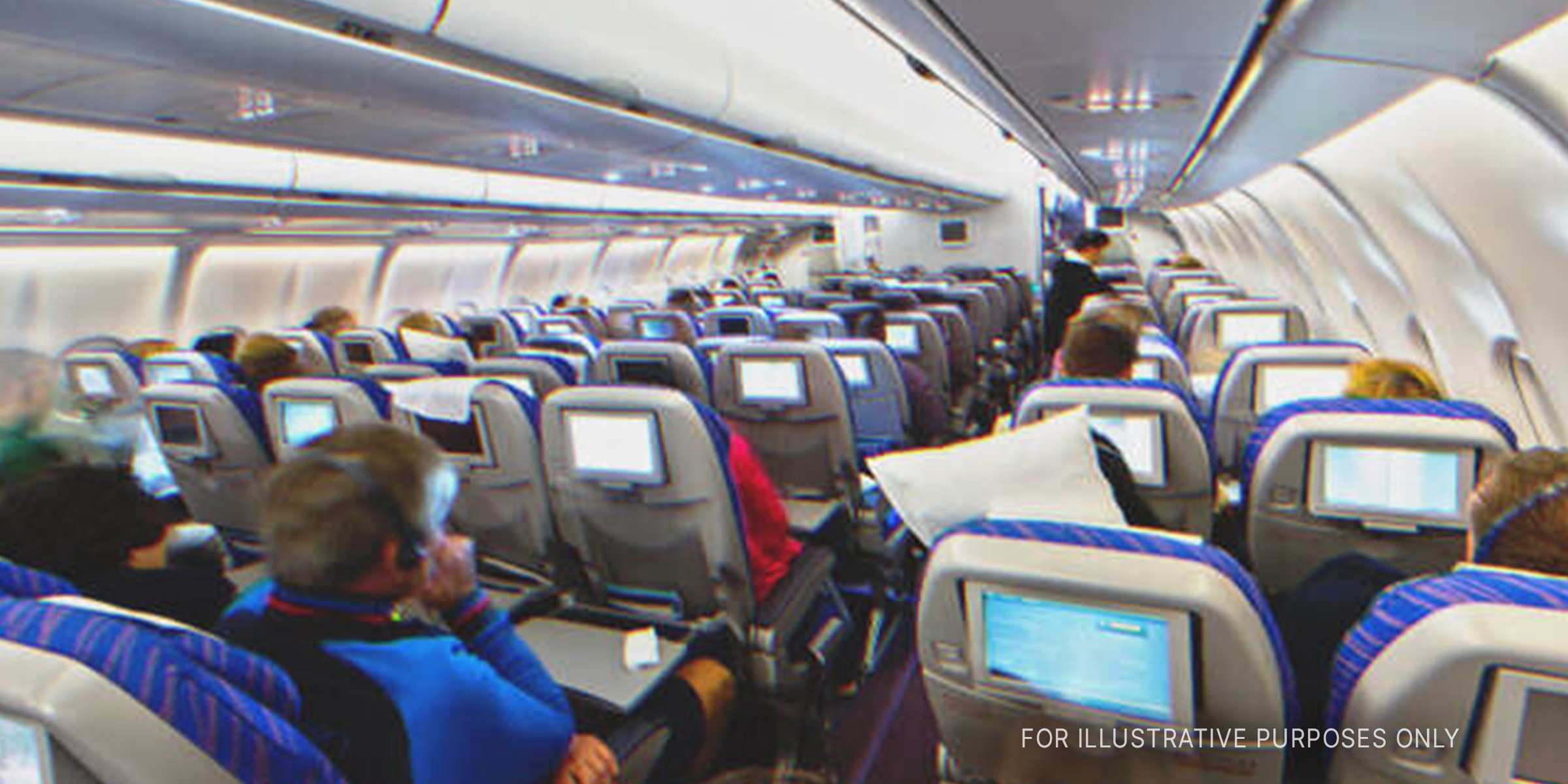 Passengers seated in an airplane | Shutterstock