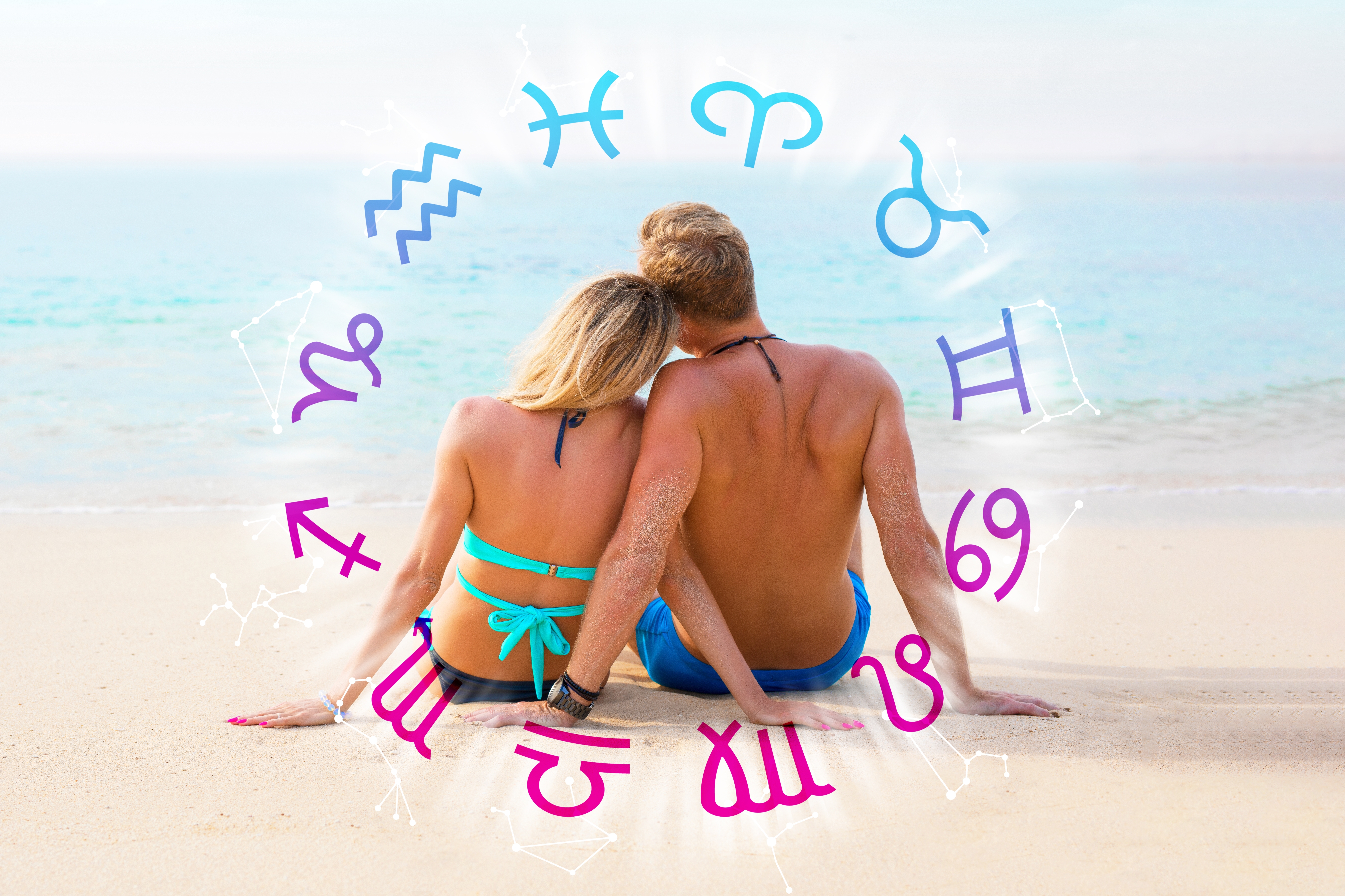 A couple relaxing at the beach surrounded by the zodiac signs | Source: Shutterstock