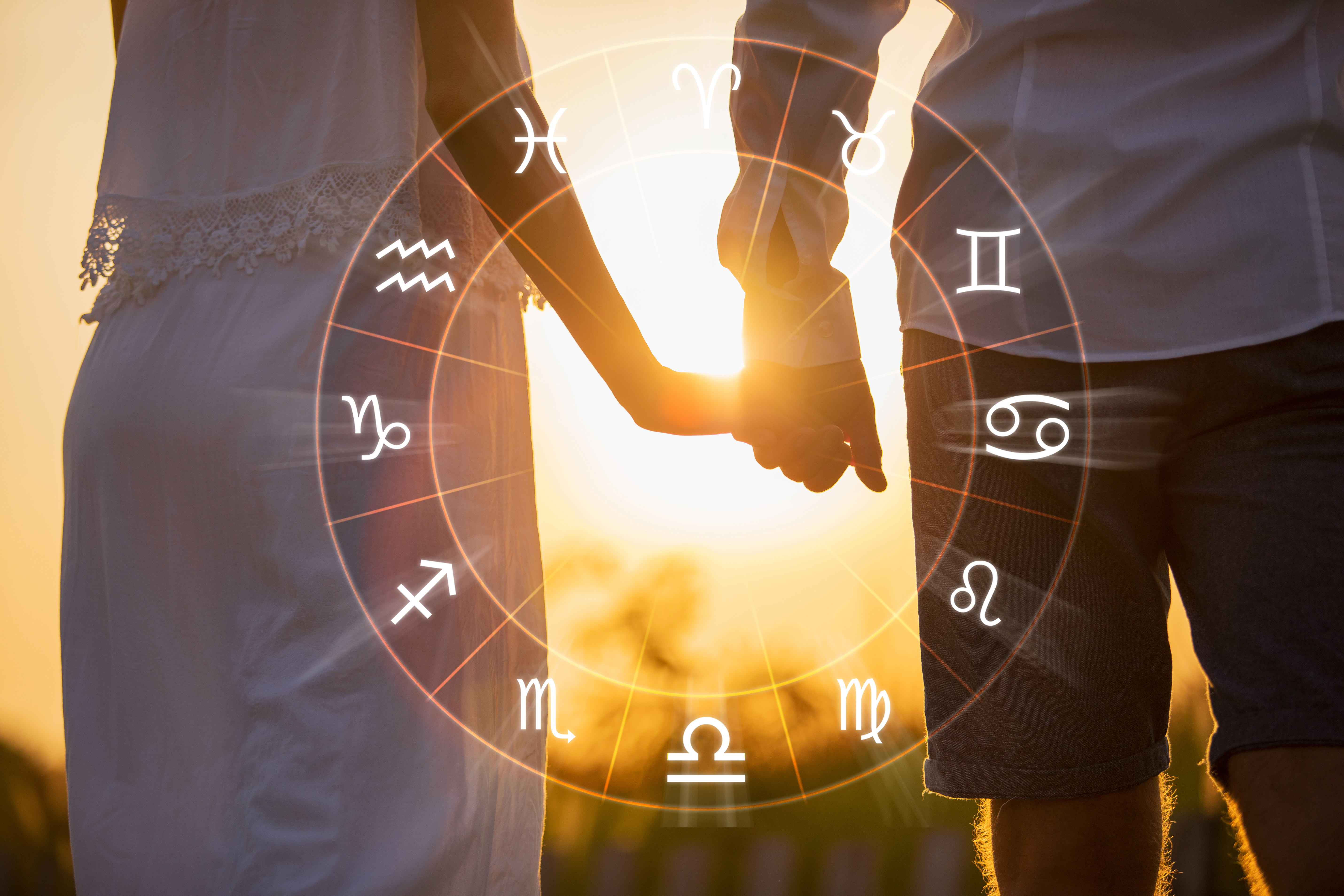 A couple holding hands inside the Zodiac wheel | Source: Shutterstock
