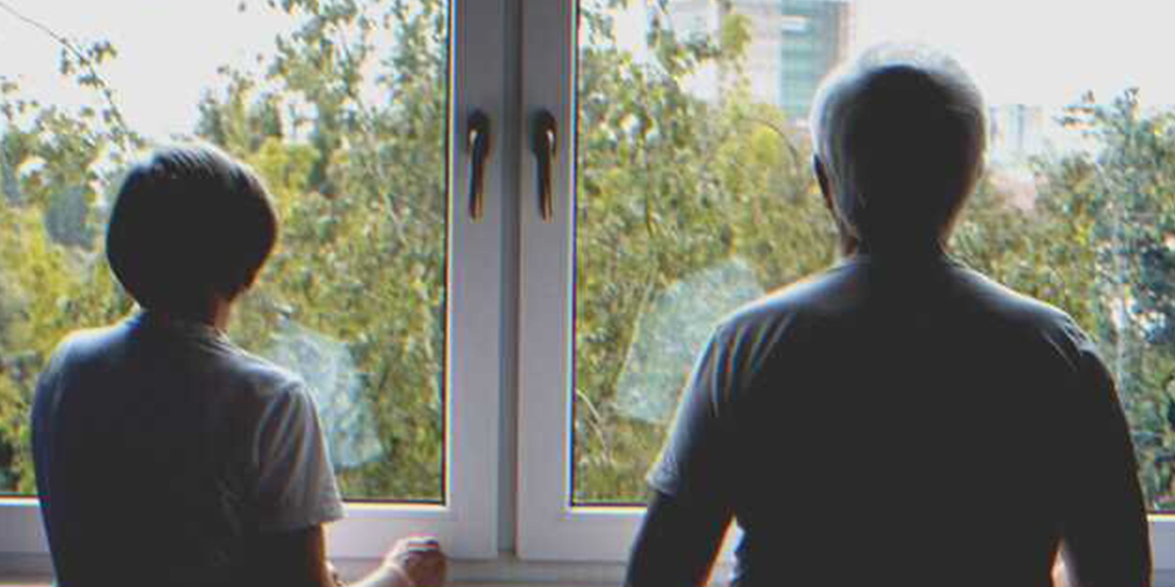 An old couple looking out the window | Source: Shutterstock