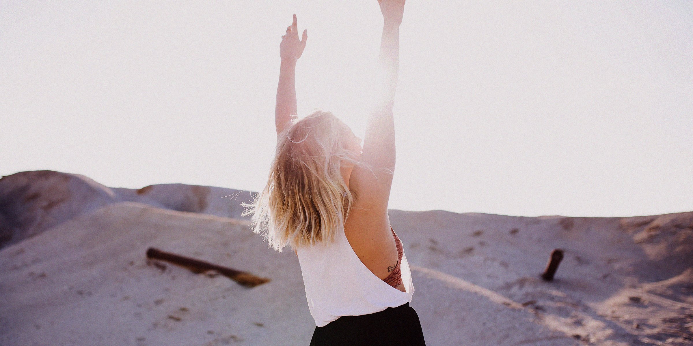 A woman holding her arms up  |  Source: Unsplash