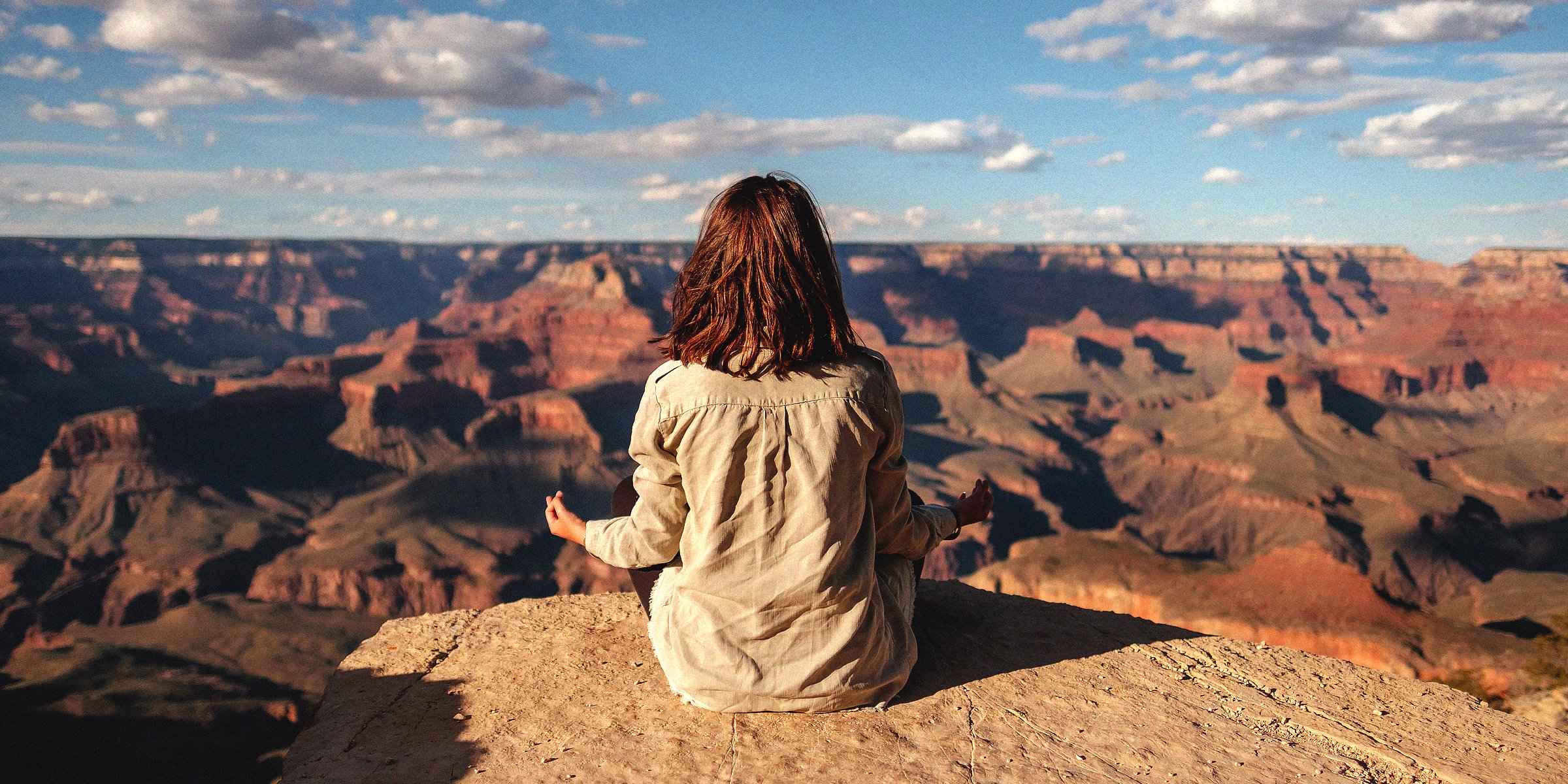 Woman meditating on a mountain | Source: Unsplash