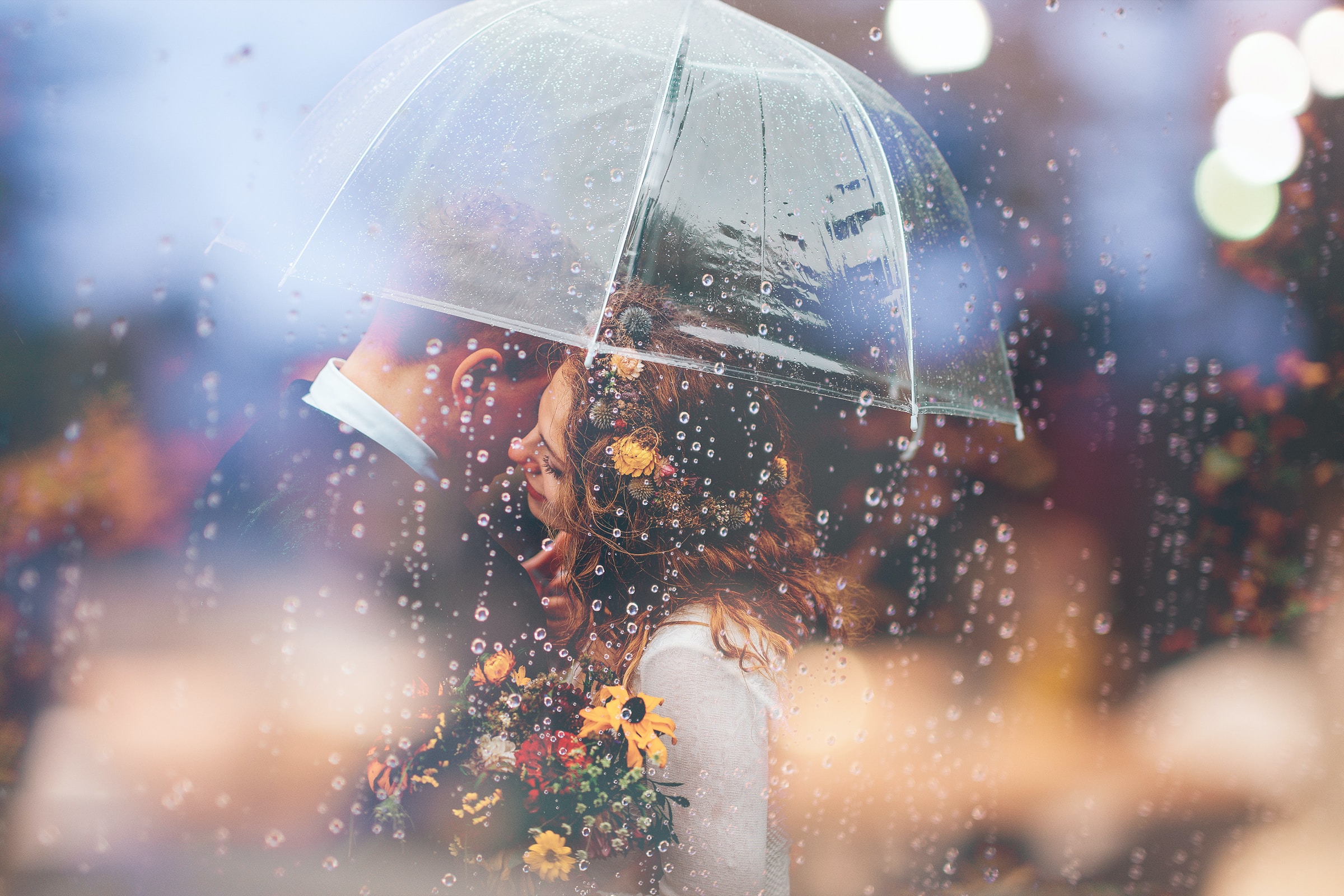 Couple embracing under an umbrella. | Source: Unsplash
