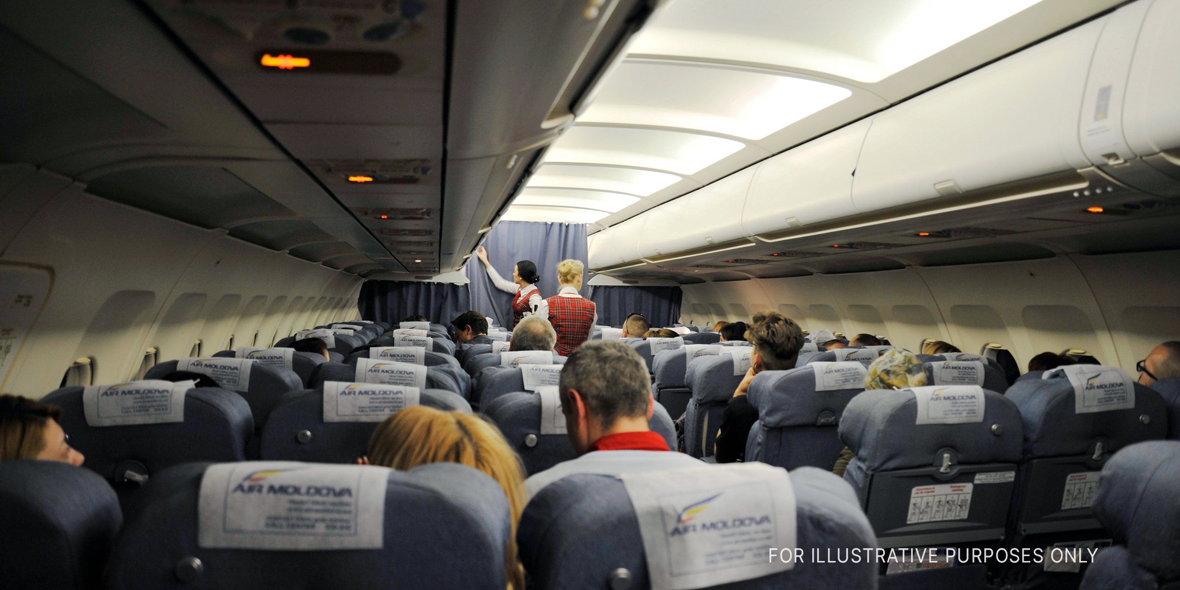 Shutterstock | Interior of an airplane with seated passengers and flight attendants