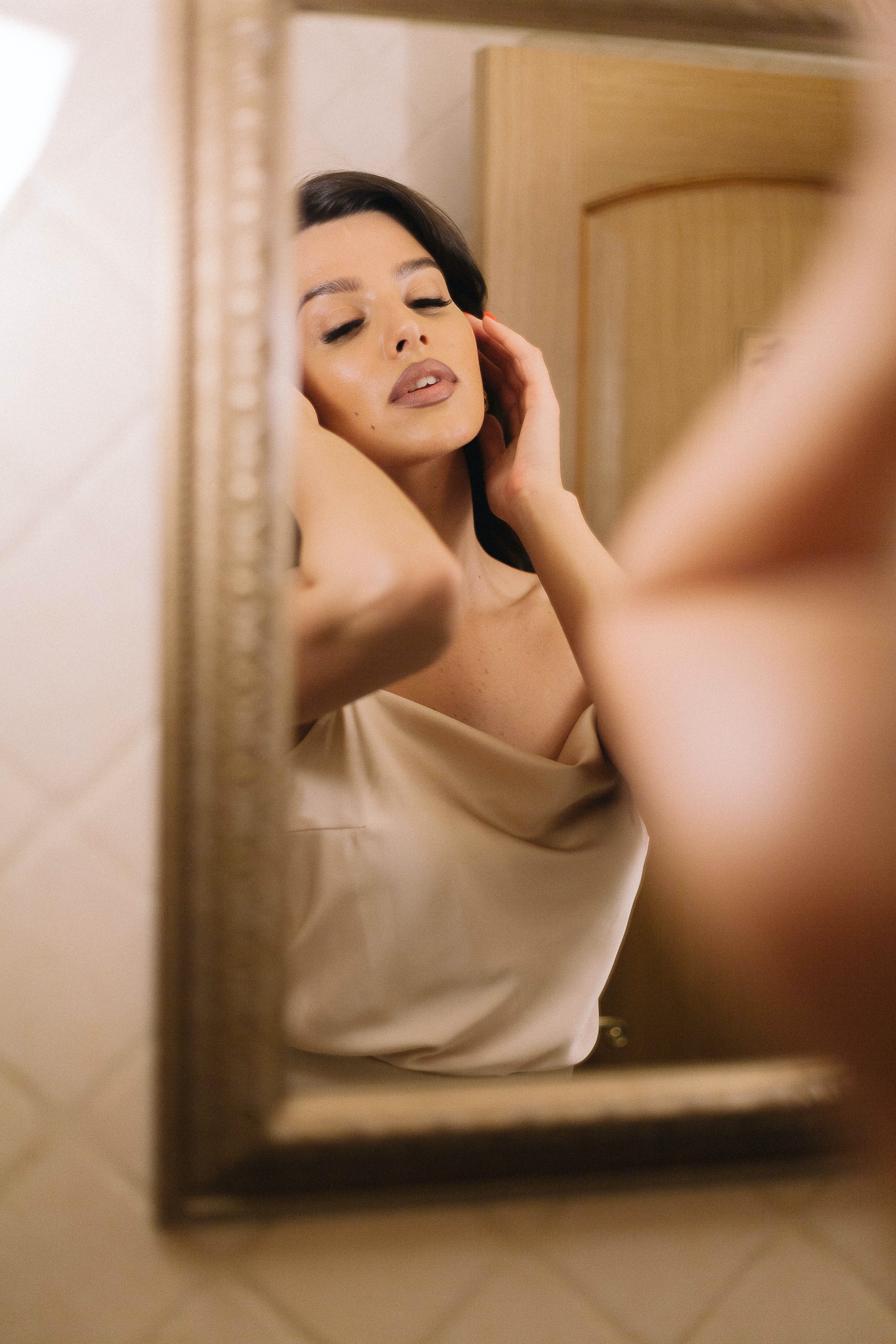 A woman looking at herself in a mirror. | Source: Pexels