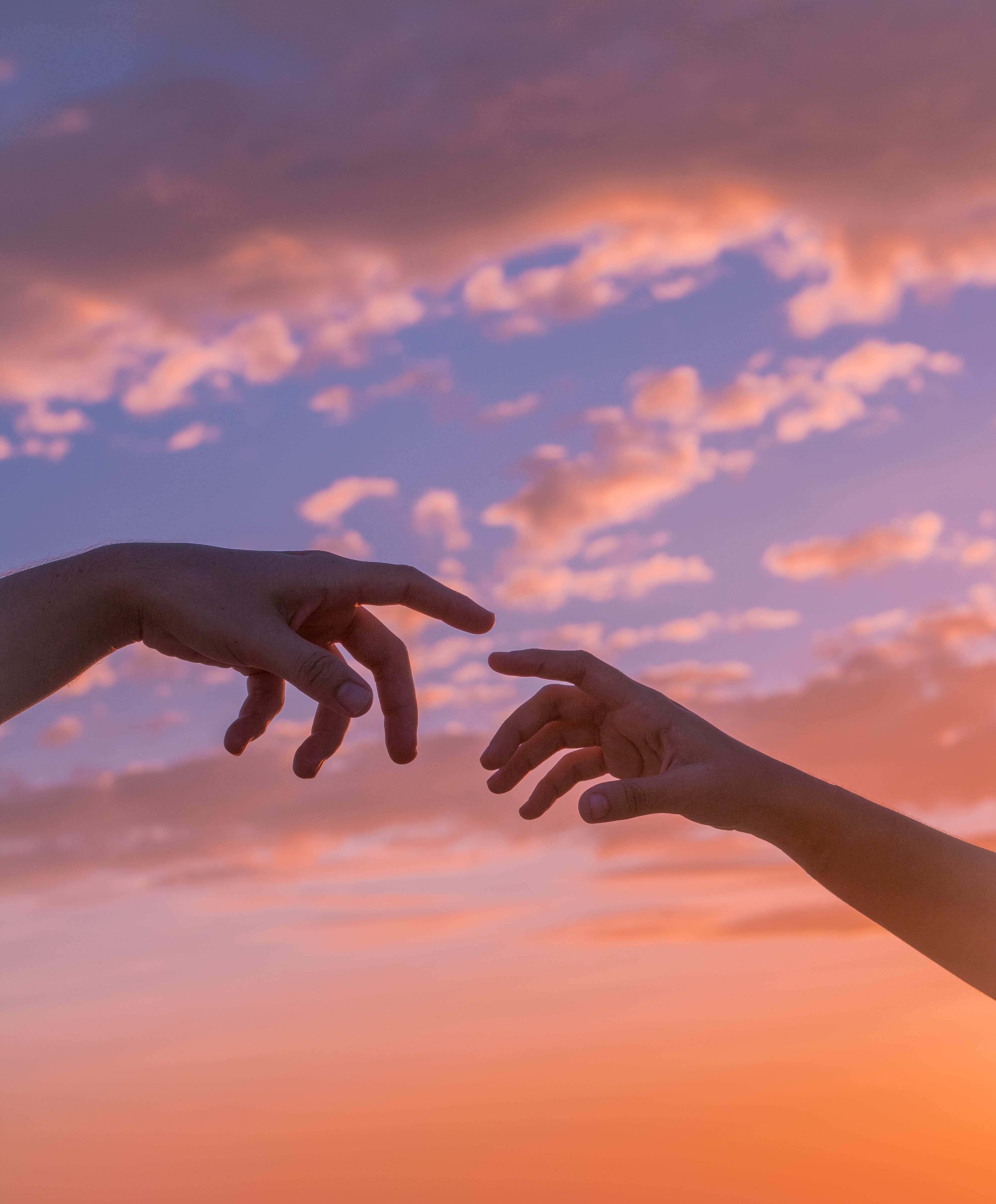 Hands reaching for each other.│Source: Pexels