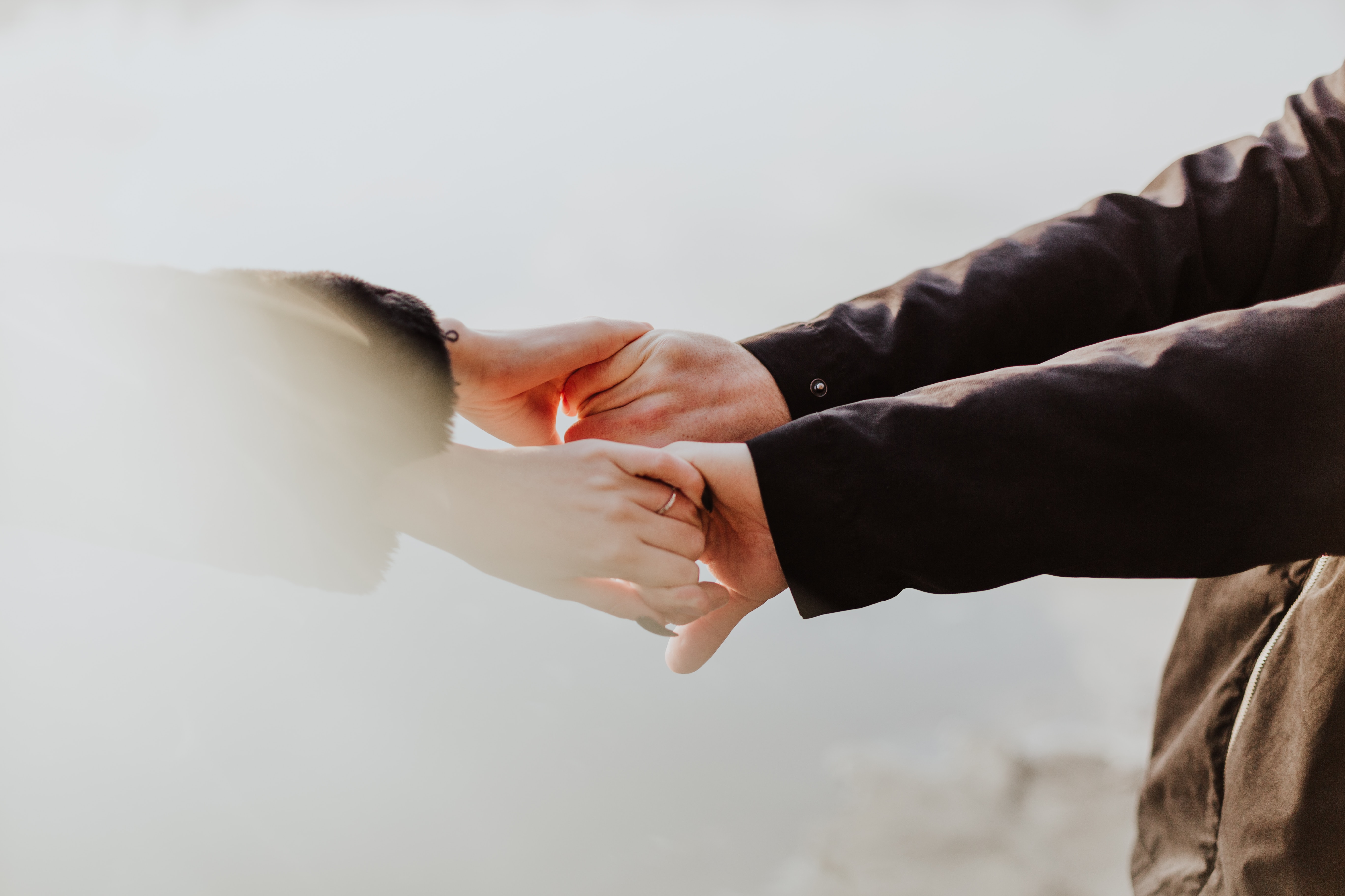 Two individuals holding hands.  │ Source: Unsplash