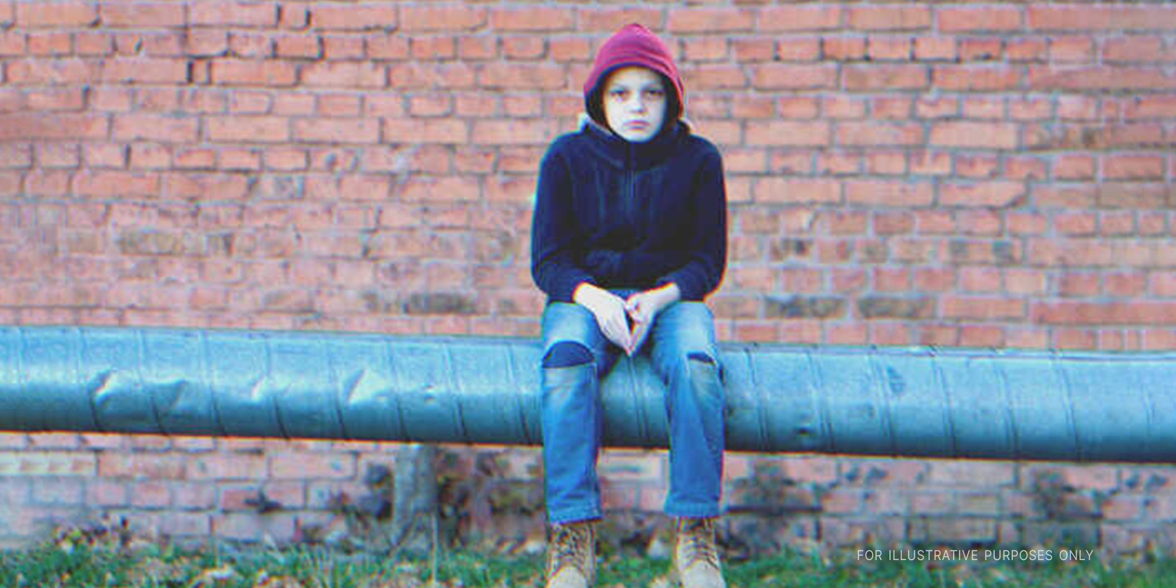 Teenage boy sitting alone | Source: Shutterstock