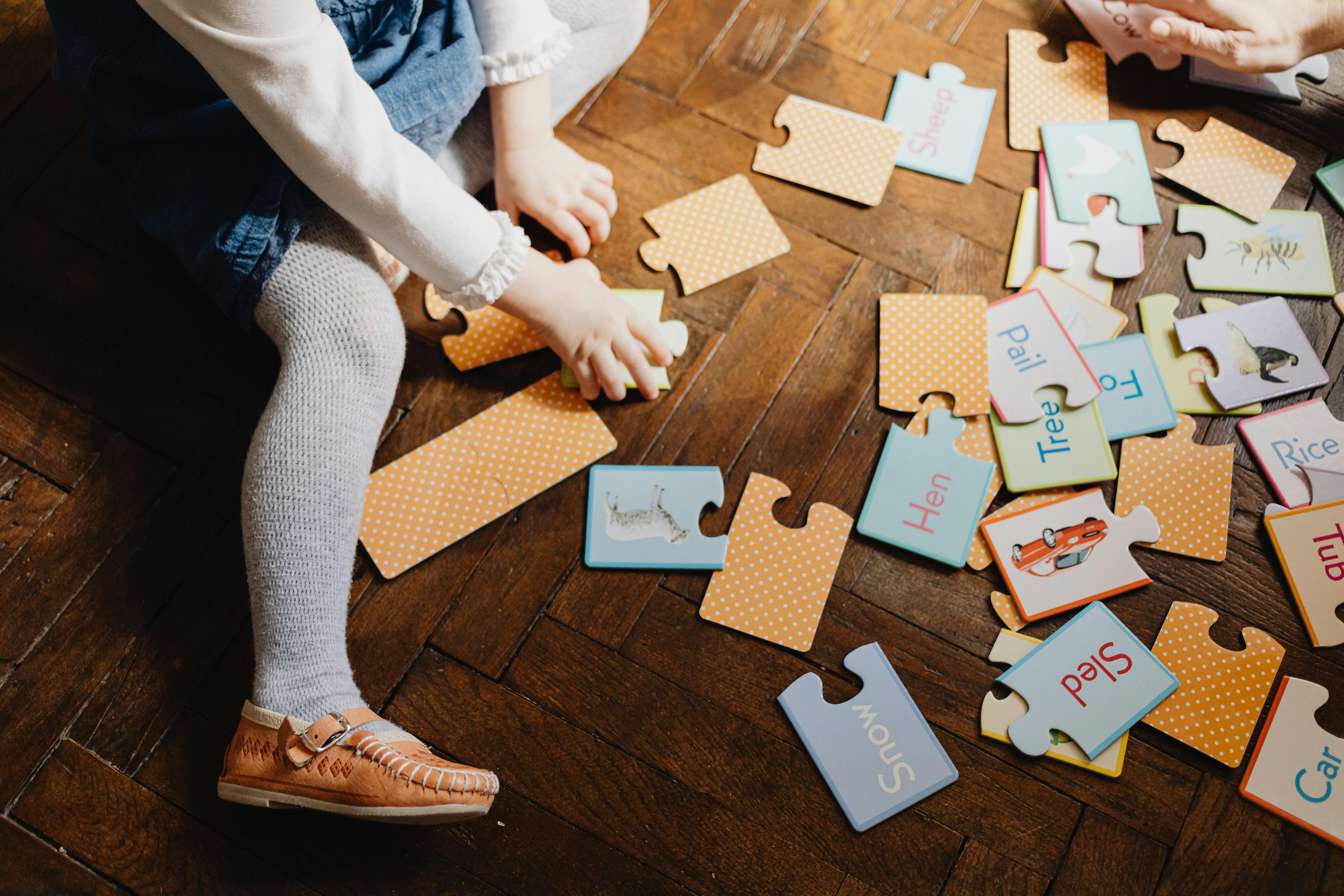 A kid playing with a word puzzle, photo taken on March 22, 2021. | Source: Pexels