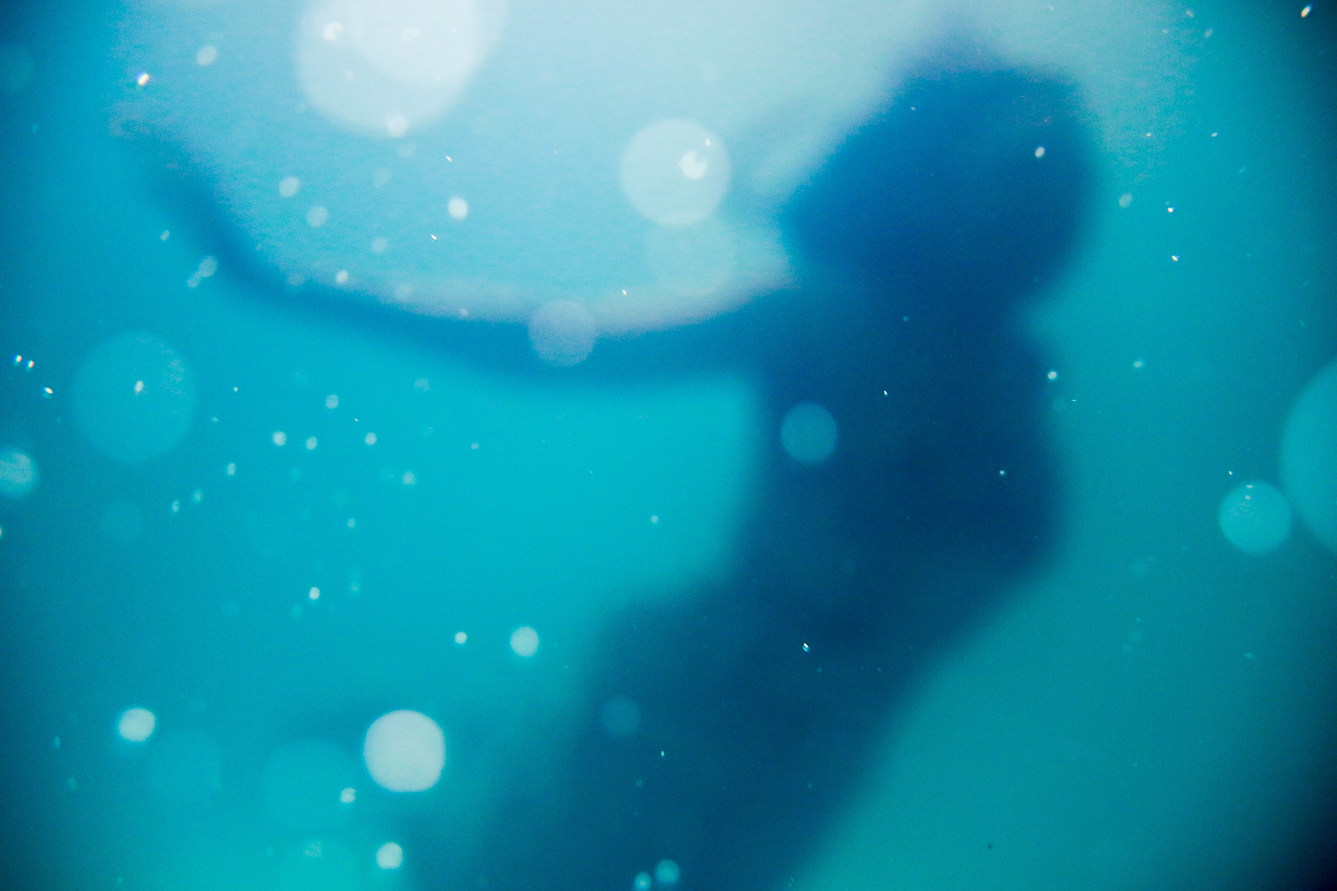 A silhouette of a woman under water. | Source: Unsplash