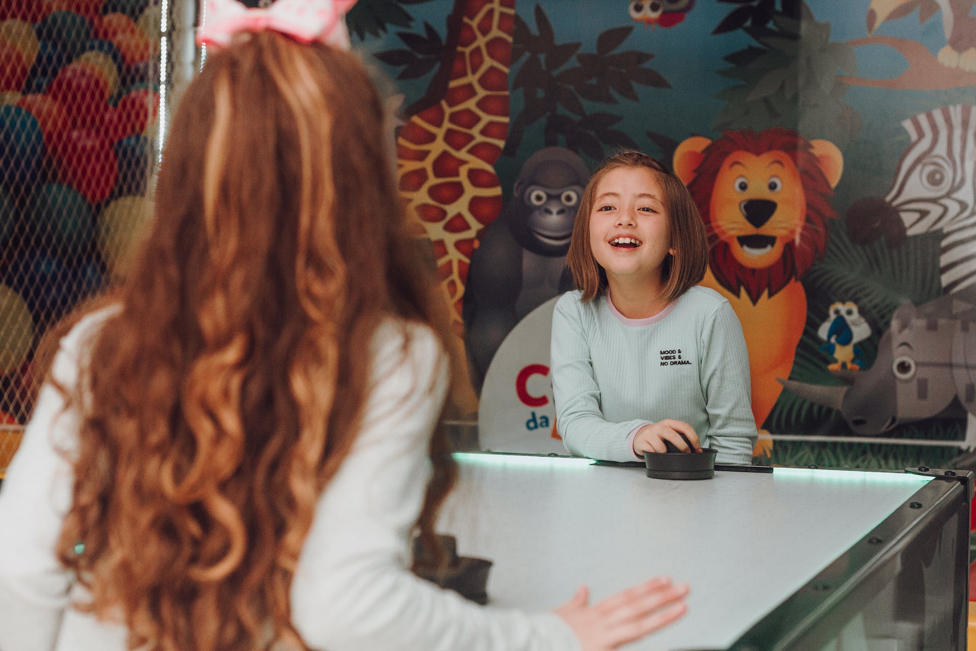 Children playing air hockey | Source: Pexels