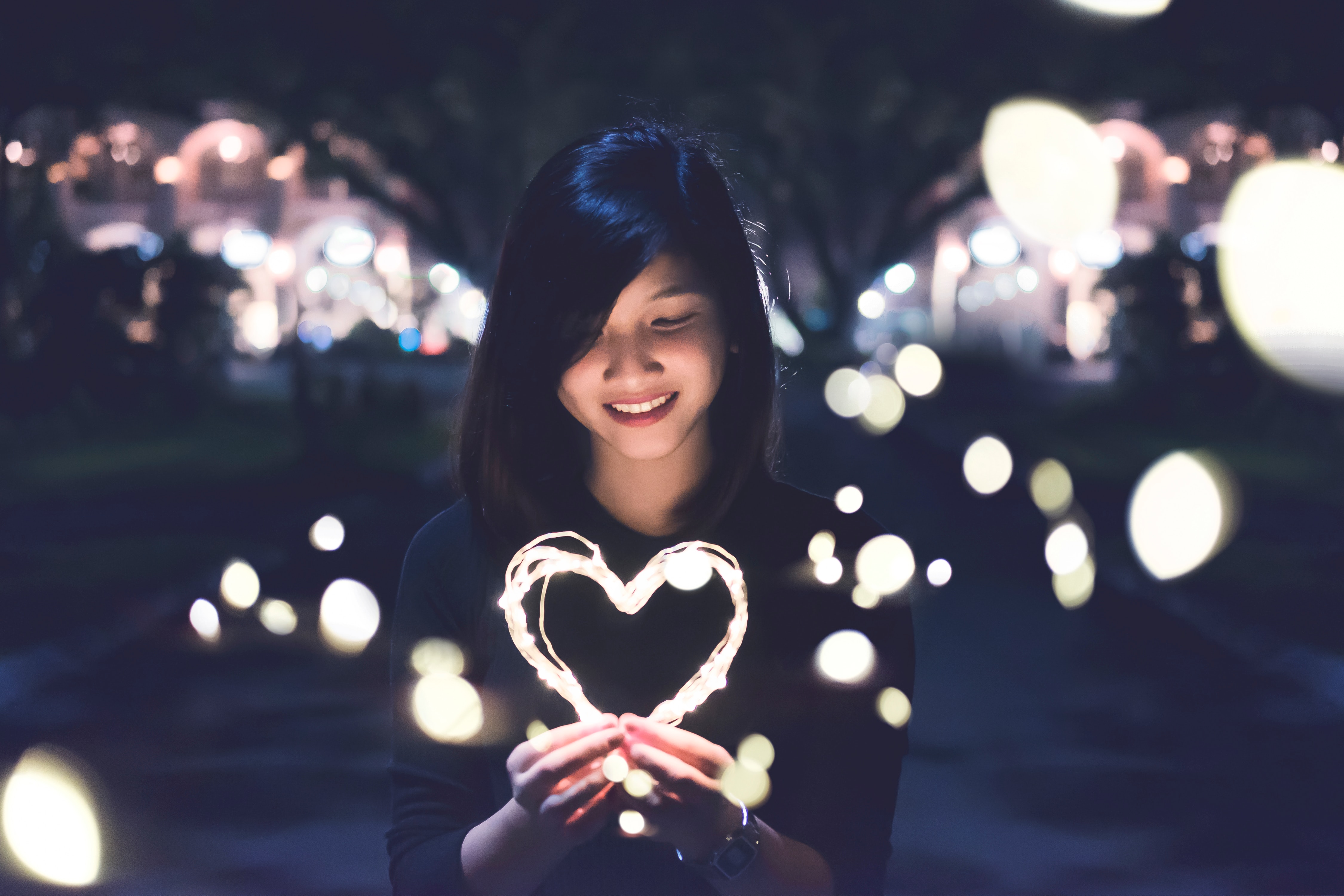 A woman holding a shining heart. | Source: Unsplash