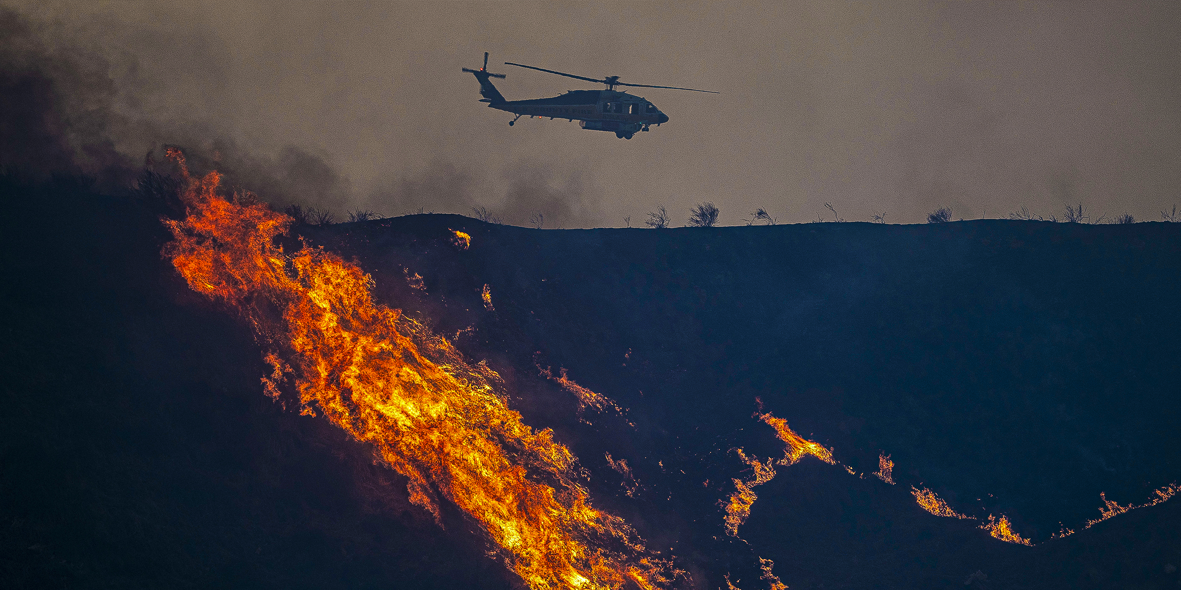 A Los Angeles County helicopter drops water over the Hughes Fire, 2025 | Source: Getty Images