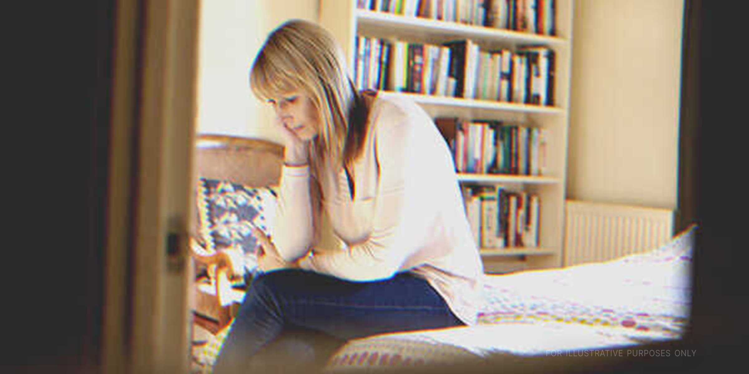 Woman thinking on bed. | Getty Images