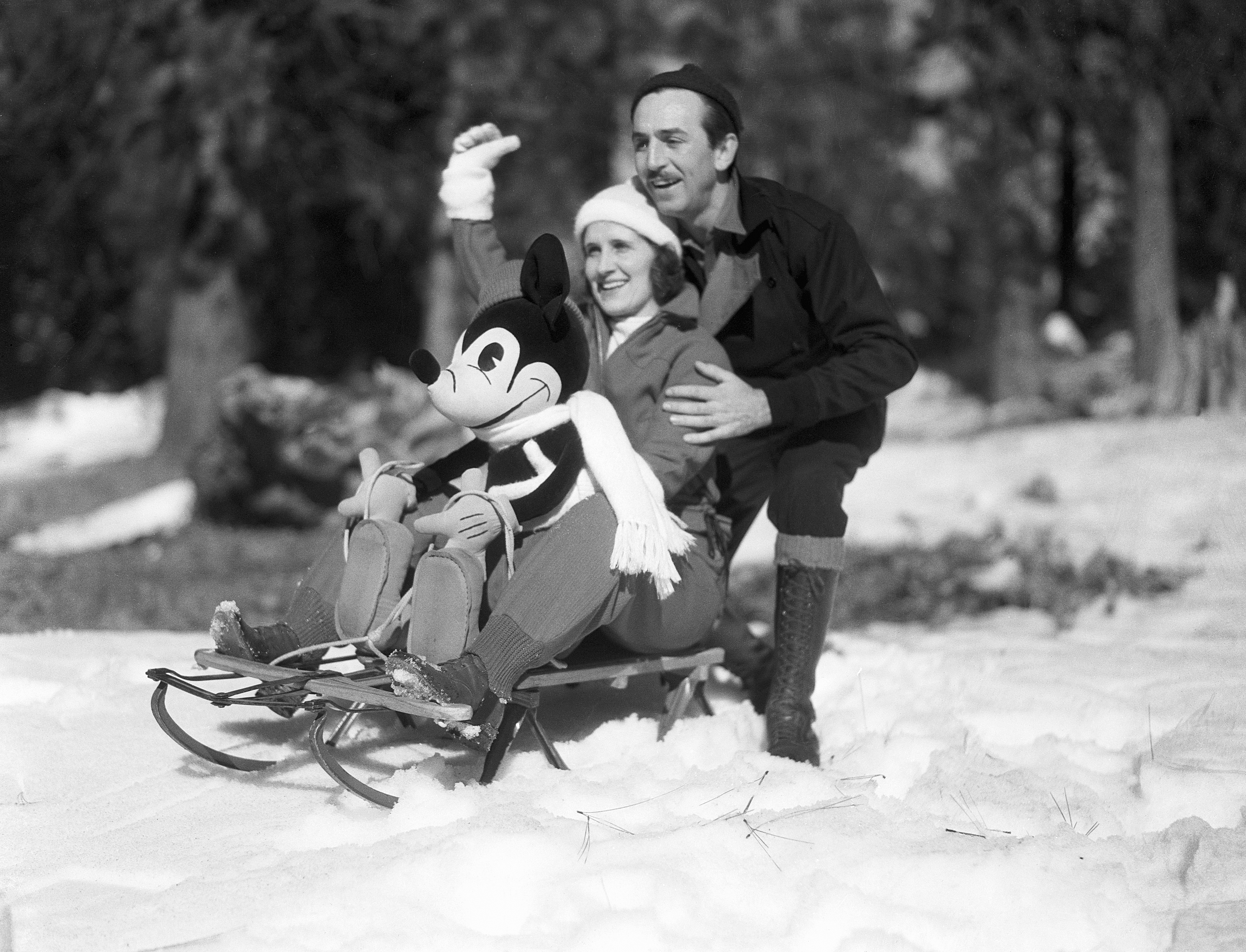 Walt Disney and Lillian Disney on a sled with a stuffed Mickey Mouse in the Lake Arrowhead resort area, on January 12, 1933. | Source: Getty Images