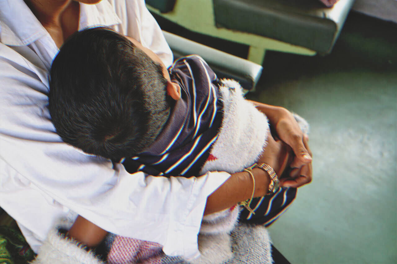 Mujer sujetando a un niño pequeño. | Fuente: Shutterstock