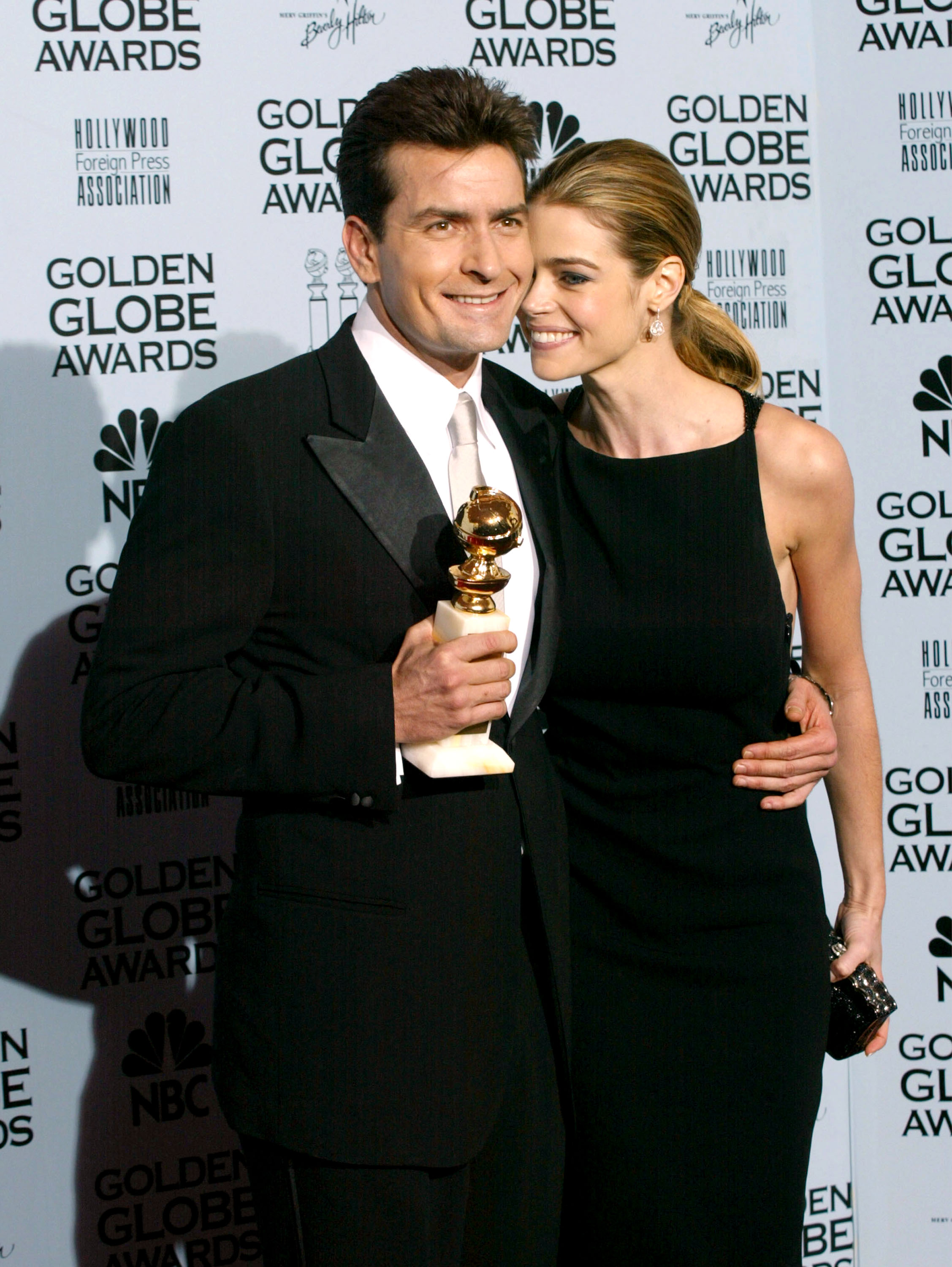 Charlie Sheen and Denise Richards pose backstage during the 59th Annual Golden Globe Awards at the Beverly Hilton Hotel in Beverly Hills, California, on January 20, 2002 | Source: Getty Images