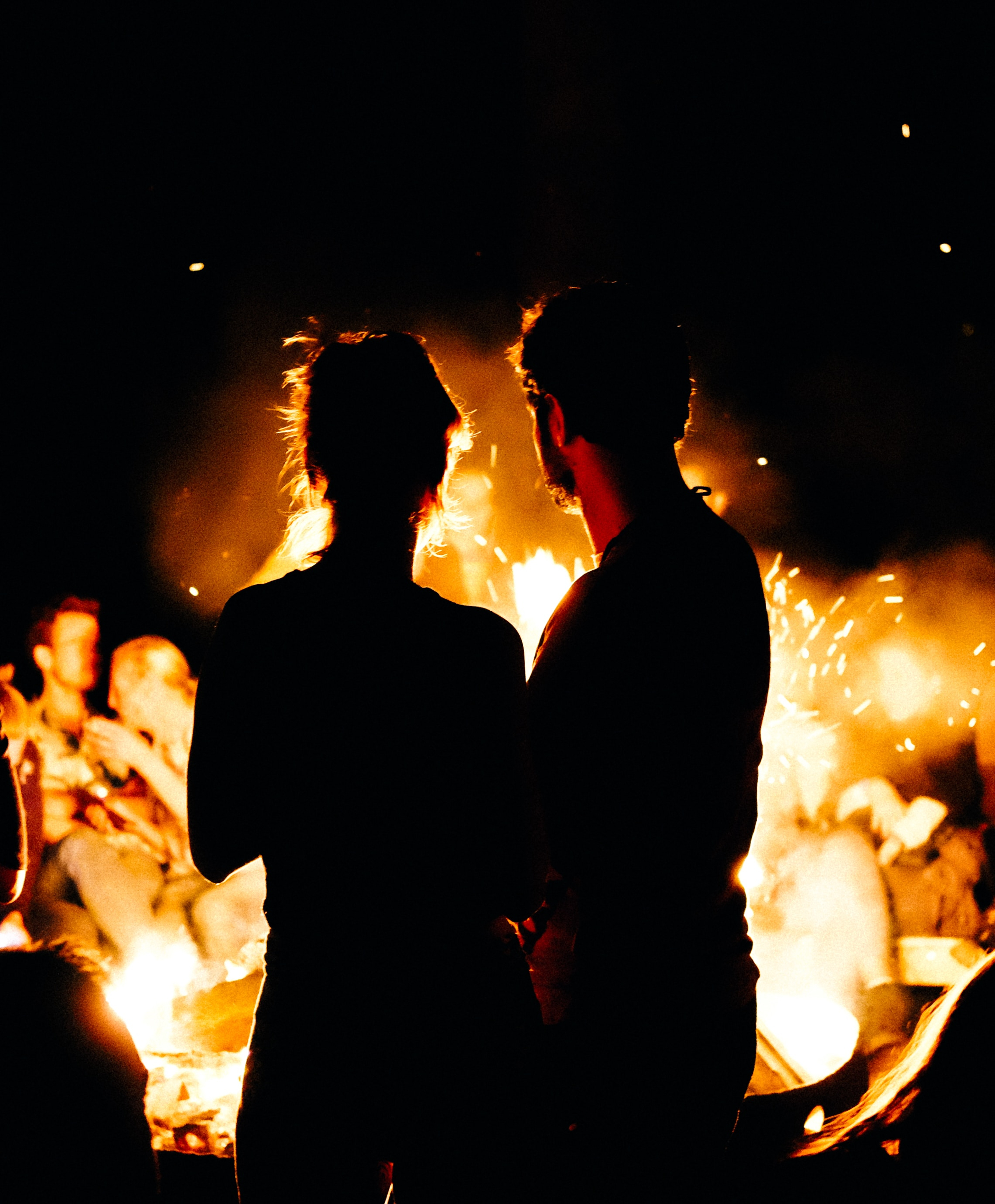 Two people standing in front of a fire. | Source: Unsplash