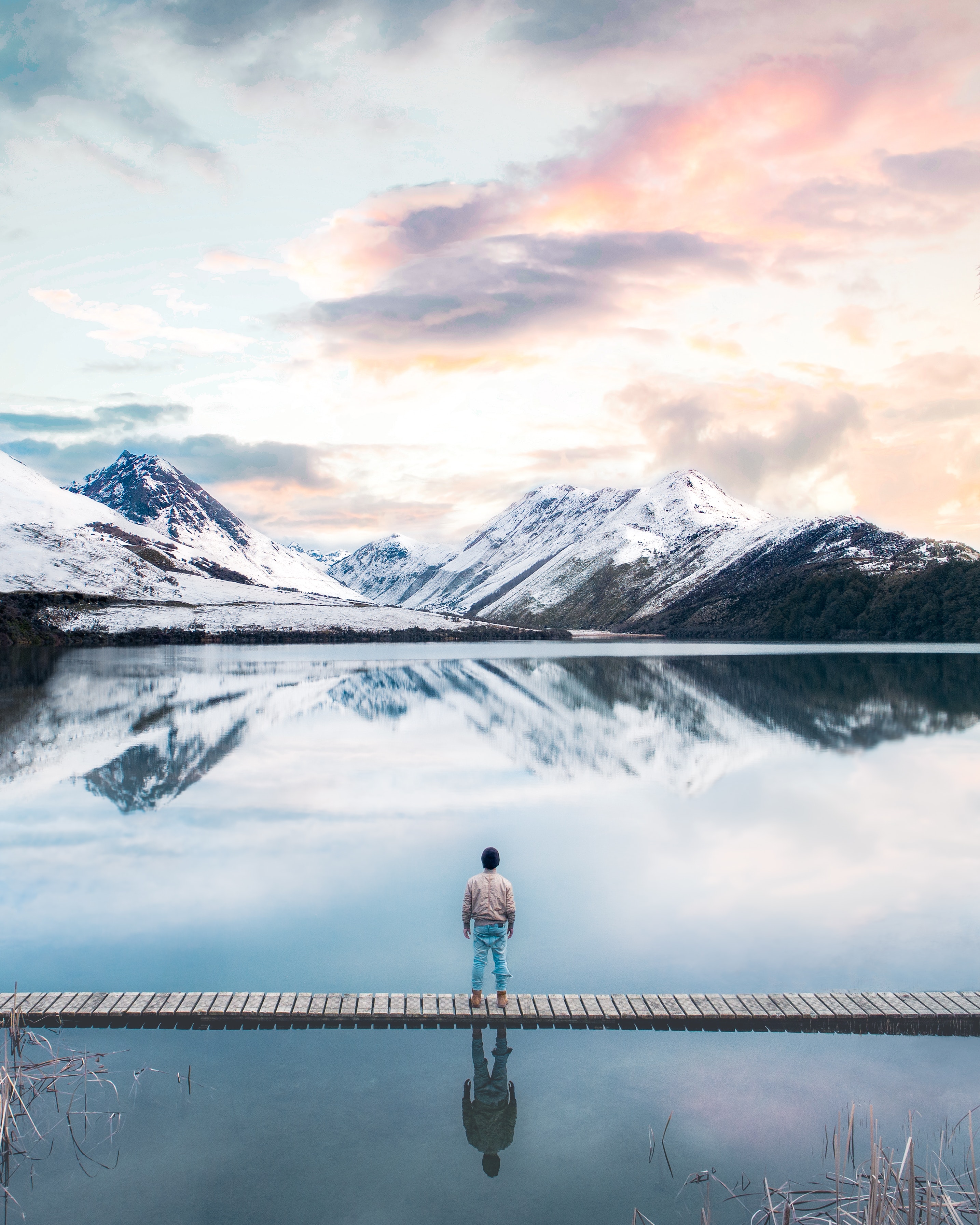 An individual looking at snowy mountains.│Source: Unsplash