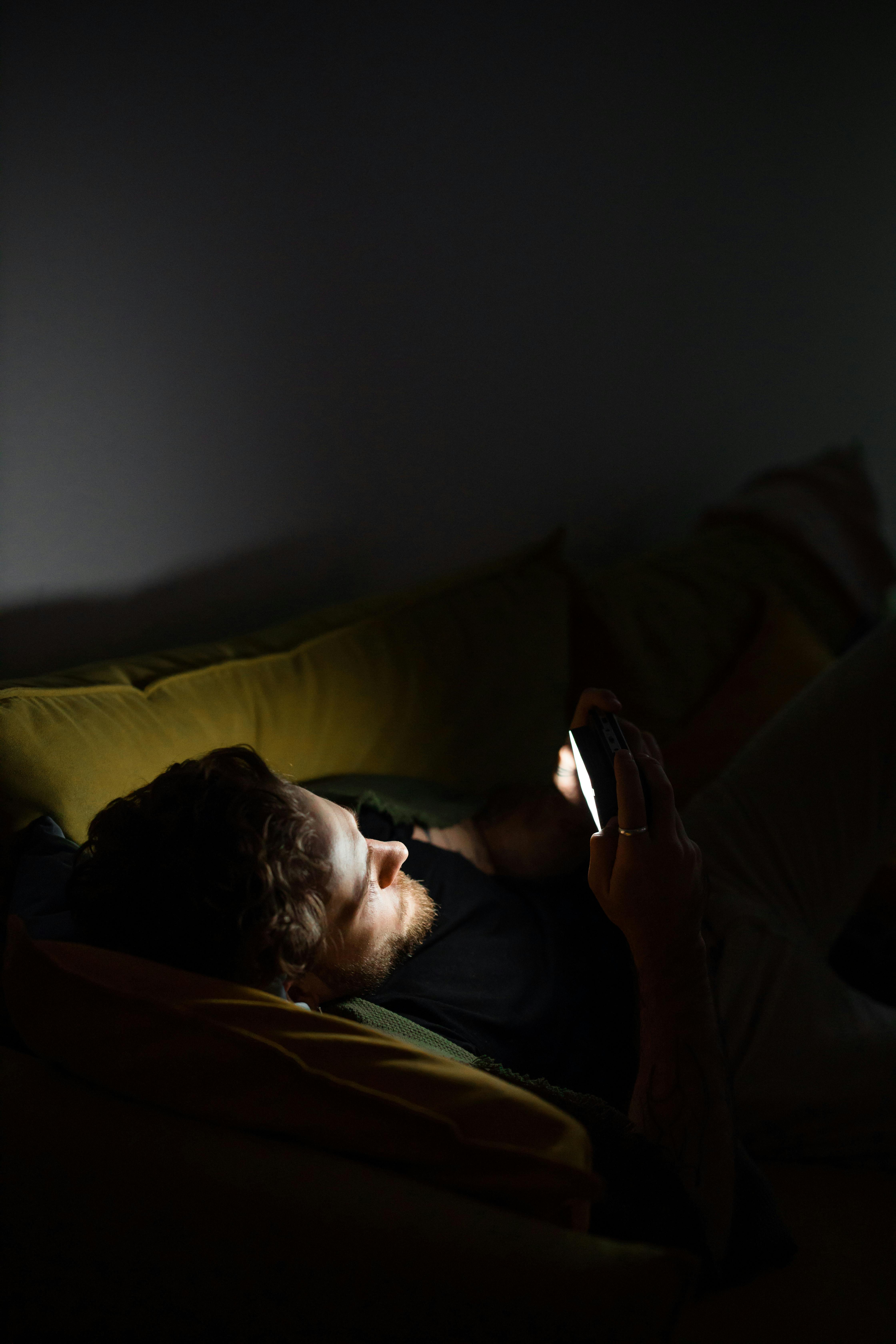 A man playing a game on his smartphone, photo taken on March 21, 2021. | Source: Getty Images