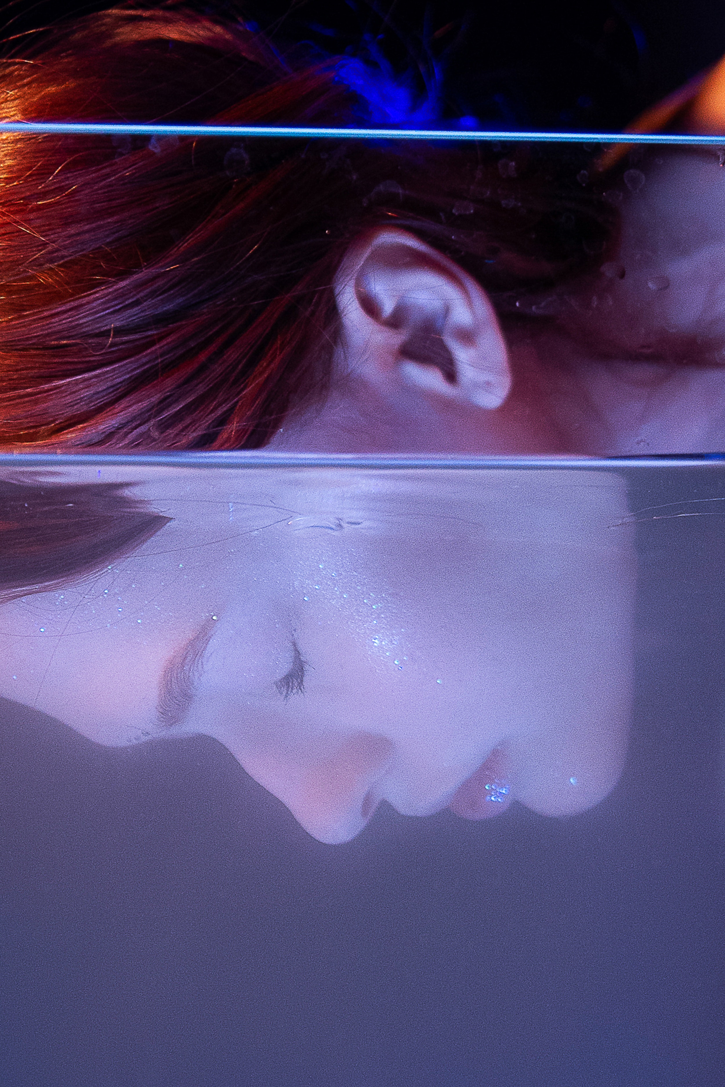 A woman underwater with her eyes closed. | Source: Pexels