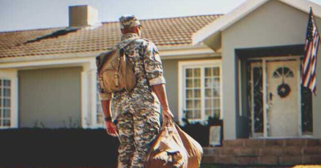 A soldier in front of a house | Source: Shutterstock