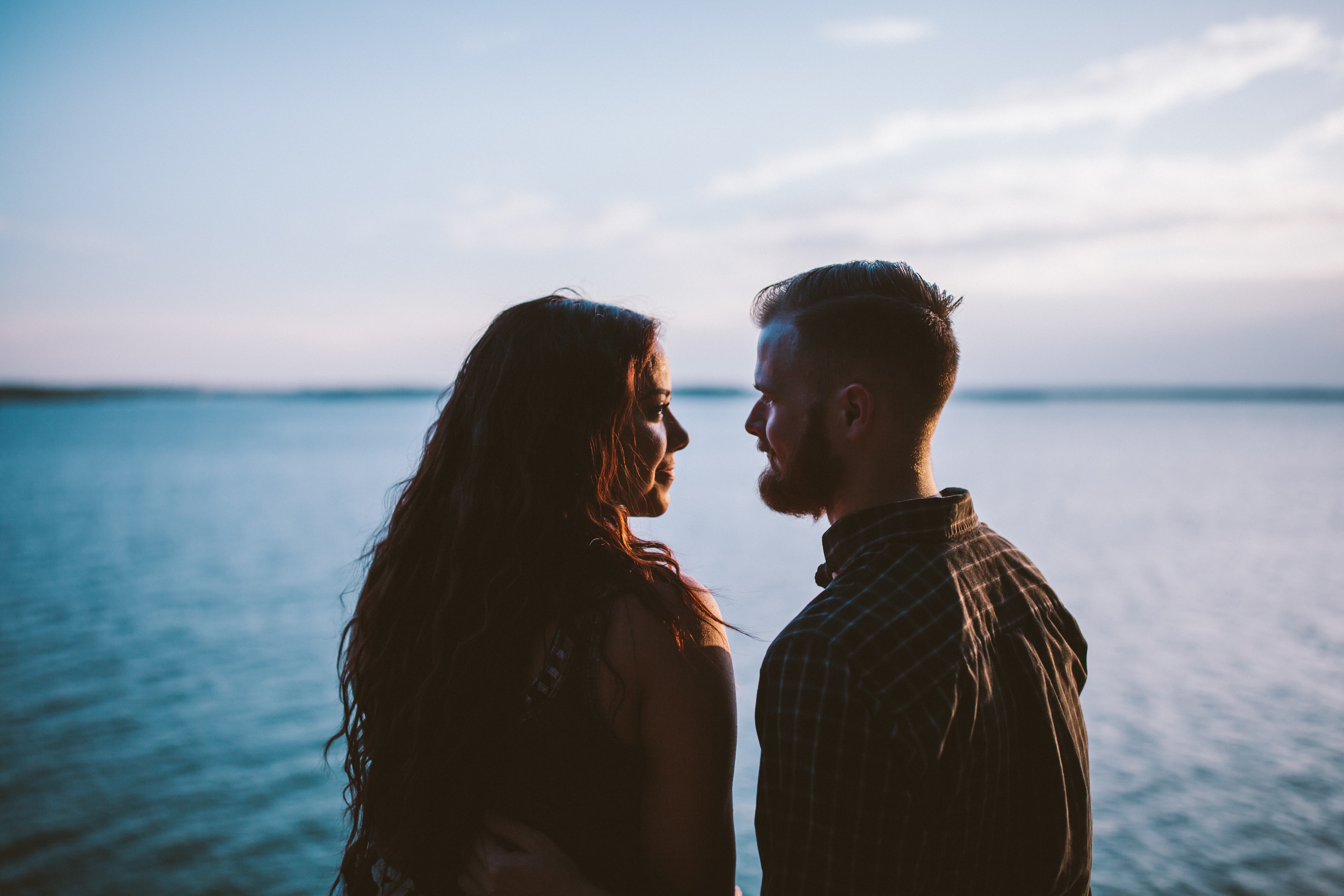 A couple looking at each other in front of the ocean. | Source: Unsplash