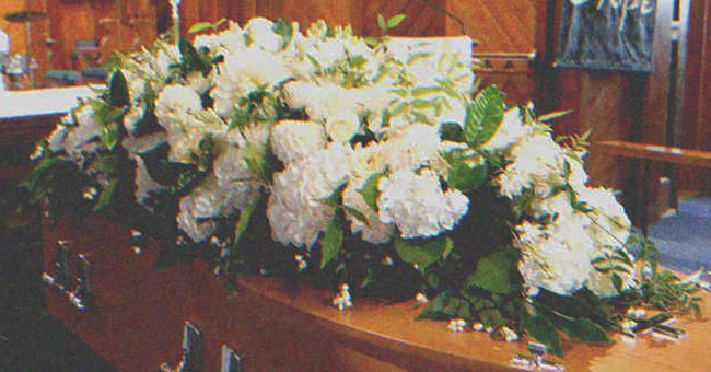 Flowers on top of a coffin | Source: Shutterstock