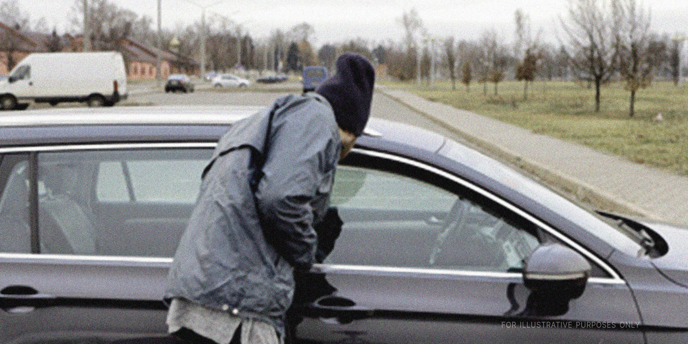 Man looking inside a car | Source: Shutterstock